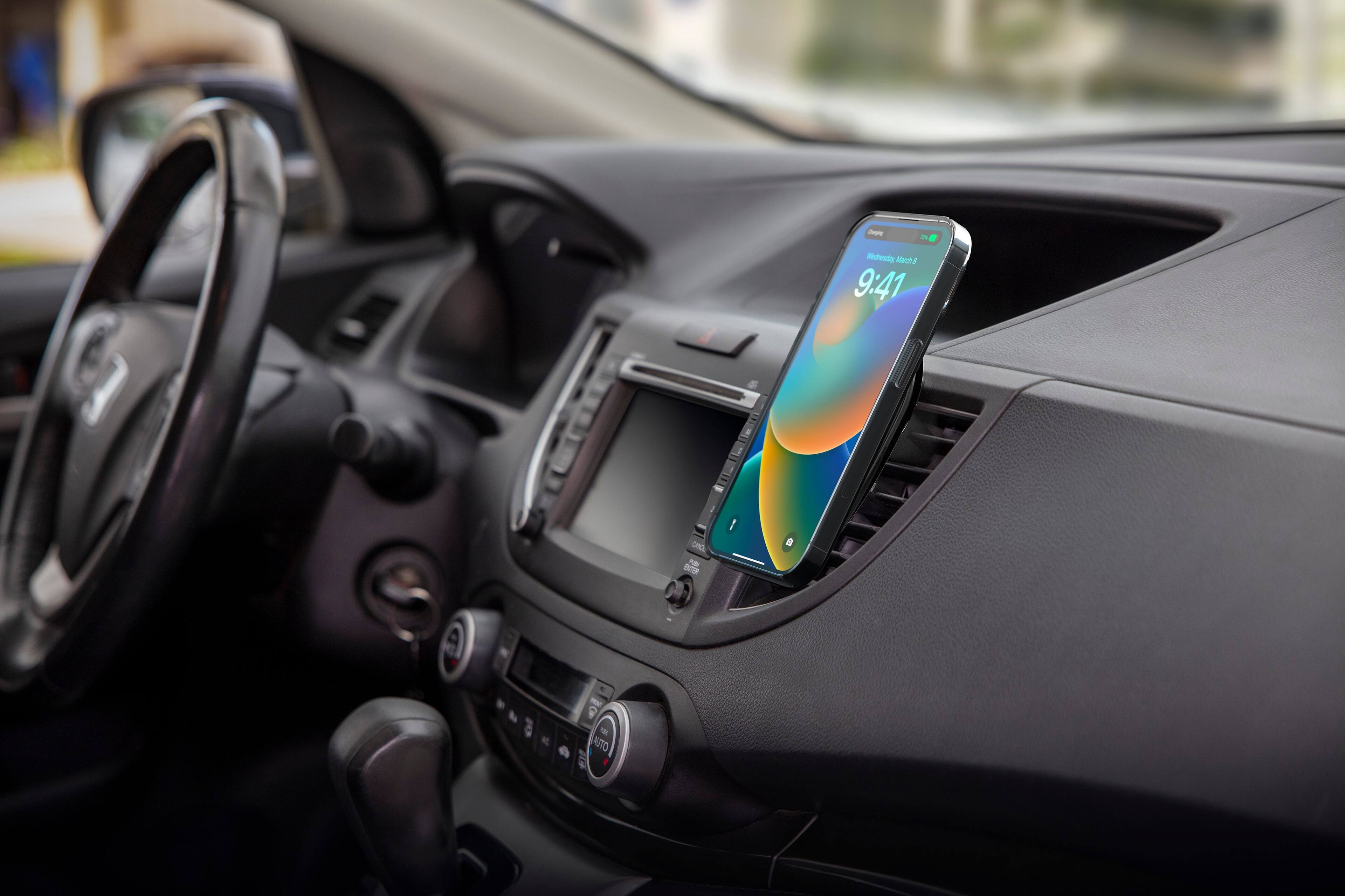 The image shows a car's dashboard with a cell phone mounted on it. The phone is displaying the time of 9:41.