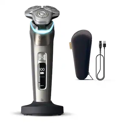 The image features a Philips Norelco 900 Prestige PM9000 electric shaver. The shaver is silver and black in color, and it is accompanied by a black pouch and a charging cord. The shaver is designed to provide a comfortable and efficient shaving experience, with a 100% waterproof feature for added convenience.