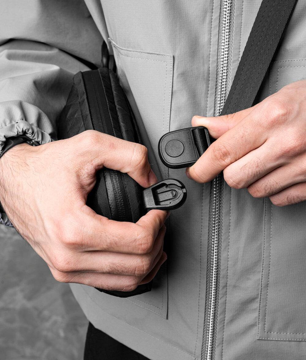 Alt View 4. ALPAKA - Flight Sling 1L Travel Sling Bag, Lightweight Crossbody Pouch, Phone Sleeve, Passport Pocket, Detachable Strap - Black Ultradyne 100D.