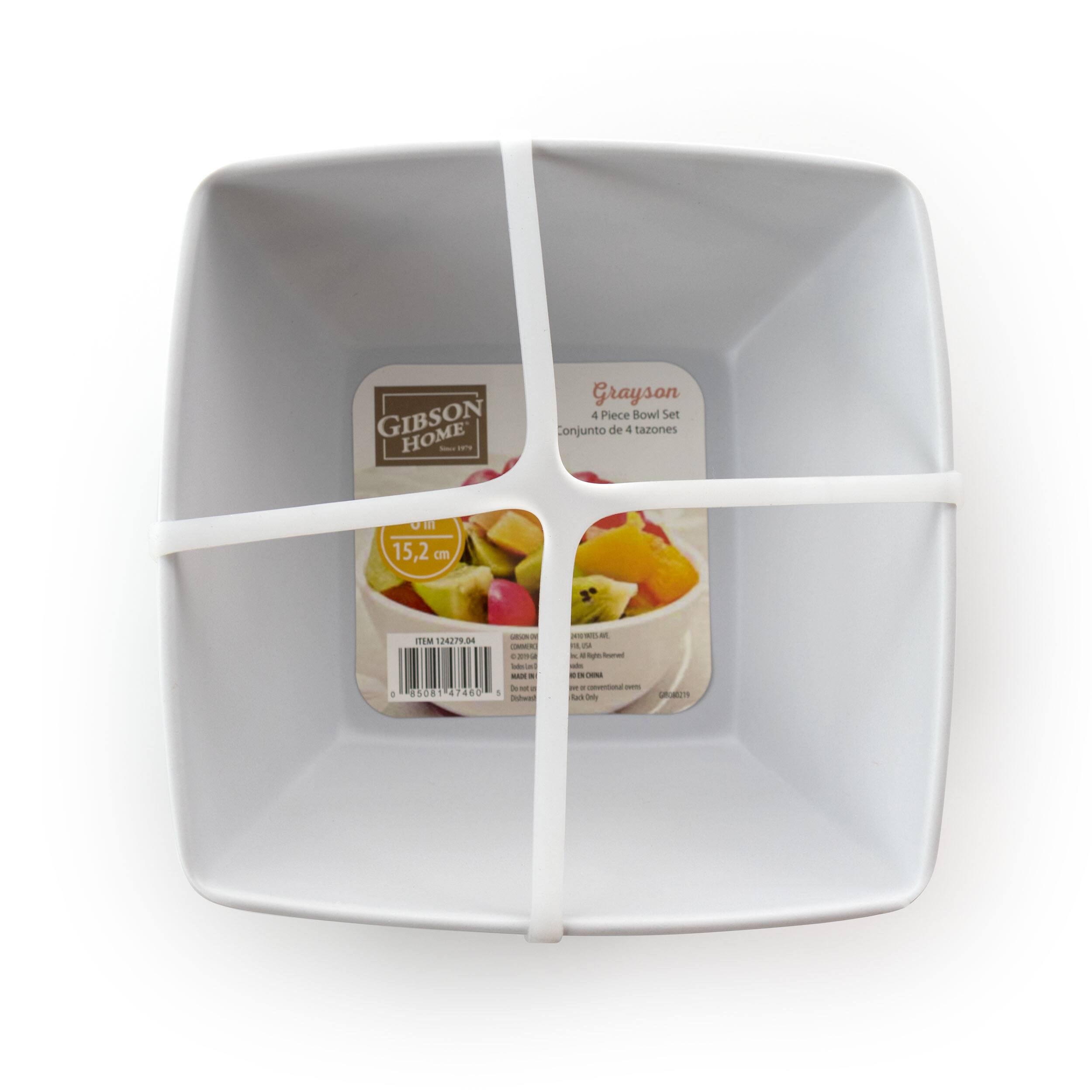 The text on the image is in Spanish, and it reads: "GIBSON HOME - Conjunto de 4 tazones E 15,2 cm. TU 239.84 85081 47460 1 - - - + - - -e - + - - LE d - - - - - - - - - - - - - dul - - -thin_to_ne." The text is describing a Gibson Home 4-piece bowl set, which includes four bowls with a diameter of 15.2 cm. The set is available in a variety of colors, and it is priced at 1.