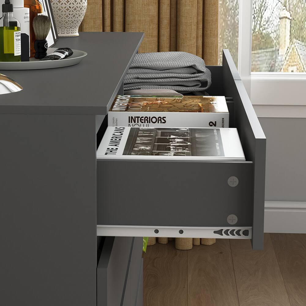 The text in the image reads:

- "INTERIORS"
- "THE AMERICANS"
- "INTERIORS" (on the magazine)
- "2" (on the magazine)