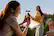 Two girls are taking a picture of each other using a cell phone.