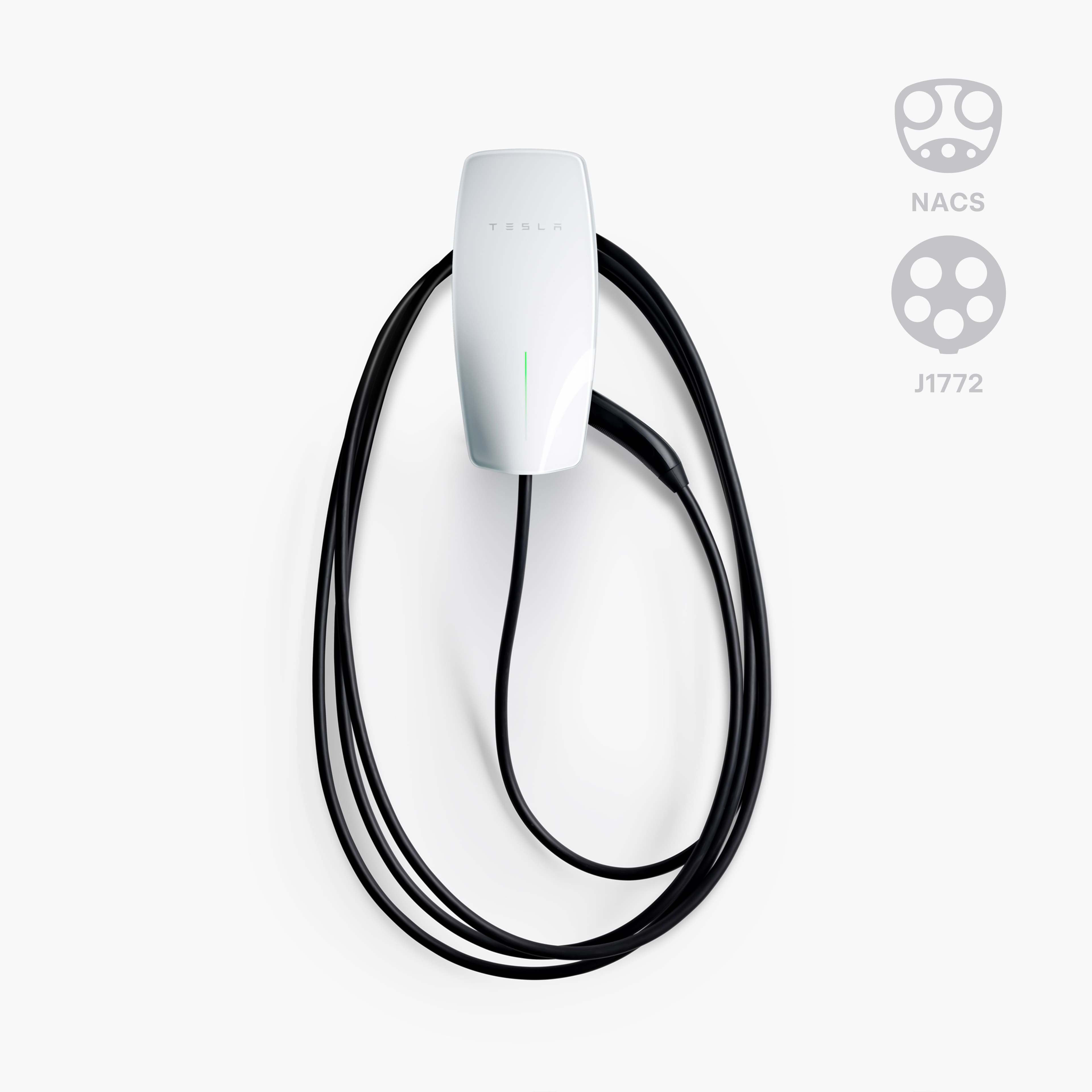 The text on the image reads "Tesla NACS J1772." This suggests that the image is related to an electric vehicle charging station, specifically designed for Tesla vehicles. The charging station is equipped with a white charger and a black cord, which is connected to the vehicle. The presence of the Tesla logo and the NACS J1772 text indicates that this is a standardized charging station for electric vehicles.