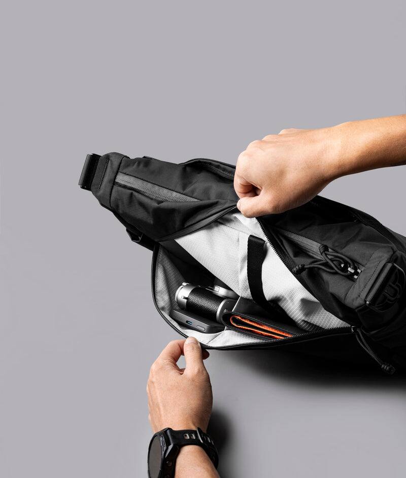 Alt View 1. ALPAKA - Laptop Messenger Satchel Bag 11L for Work & Travel, Fits 13" MacBook Air, Bottle Pockets, Luggage Pass-Through - Black Axoflux 210D.