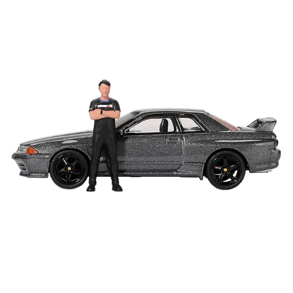 Angle. Mini GT - Nissan Skyline GT-R (R32) RHD (Right Hand Drive) Gunmetal Gray Metallic with Tsugio Matsuda Figure Limited Edition 1/64 - Gunmetal Gray.