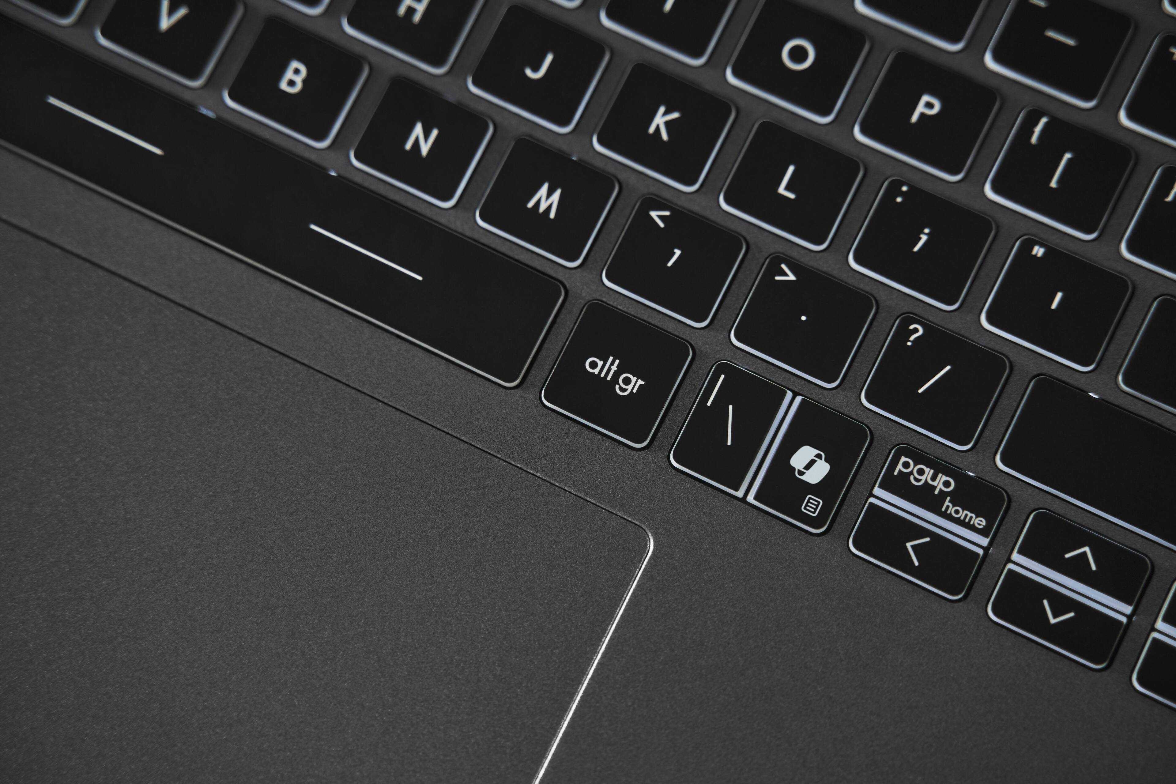 The text on the image reads: "V h N . J K M < 1 alt gr | O L > . P : i ? / pgup home < I - { [ " I 7 L 1". This text appears to be a mix of keyboard keys and symbols, possibly representing a keyboard layout or a keyboard shortcut. However, it is not a coherent sentence or phrase.