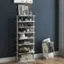 A white shelf with a variety of items on it, including books, a vase, and a potted plant. The shelf is placed against a blue wall.