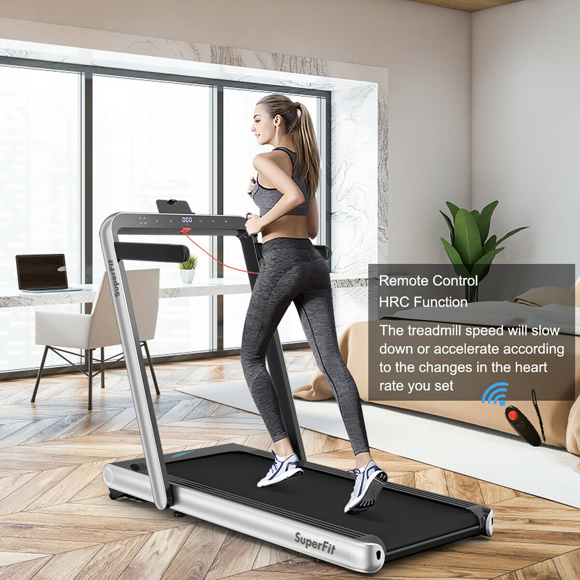 The image features a woman standing on a treadmill in a living room. The treadmill has a remote control function that allows the speed to slow down or accelerate based on changes in the user's heart rate. This feature is called the HRC Function. The woman is wearing a grey outfit and appears to be using the treadmill for exercise. The living room has a couch and a potted plant, adding to the cozy atmosphere.