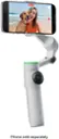 The image shows a white cell phone holder with a phone attached to it. The phone is sold separately, as indicated by the text.