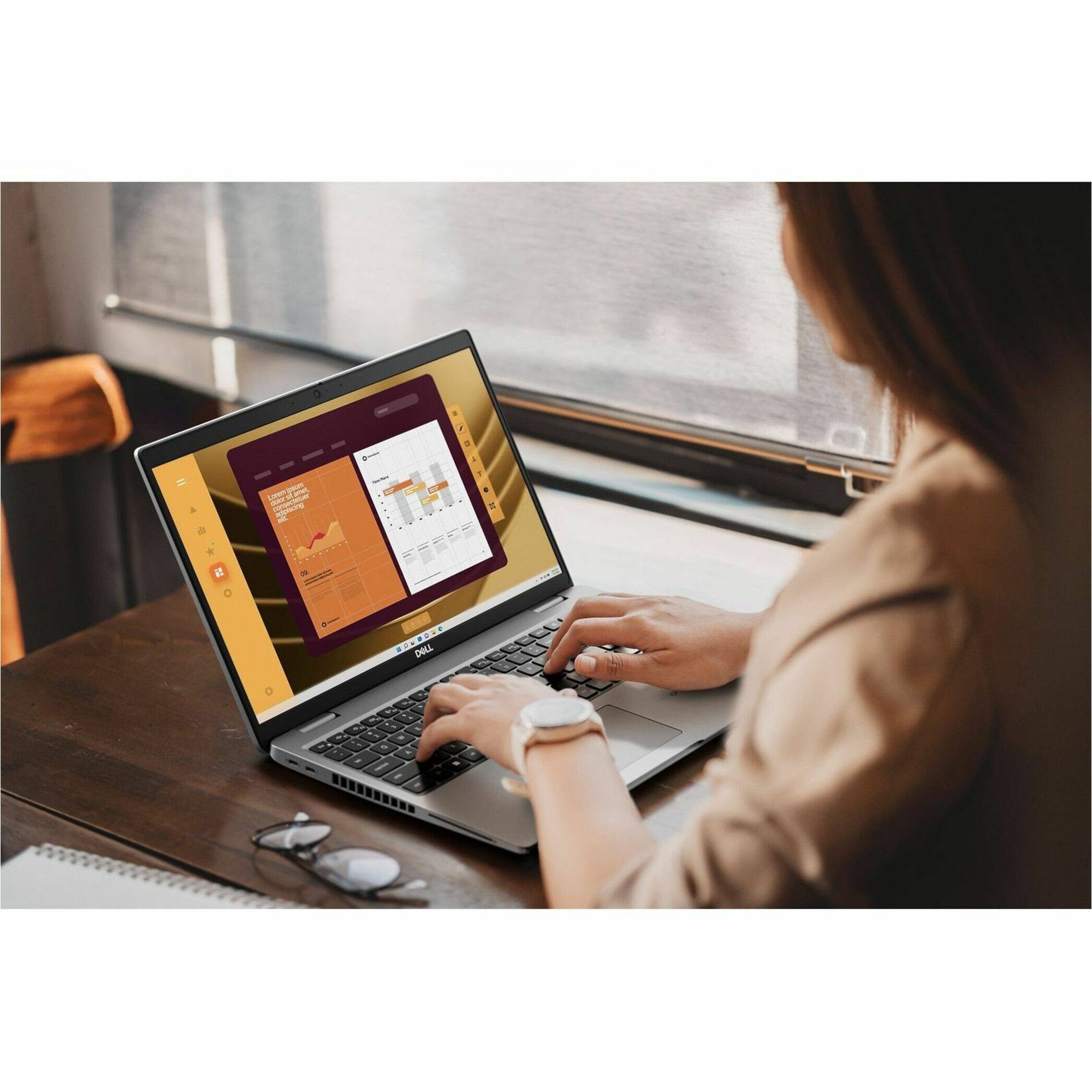 The image features a woman using a laptop computer. The laptop is placed on a desk, and the woman is sitting in front of it. The laptop screen displays a graph, indicating that she might be working on a project or analyzing data. The woman is wearing a watch, which is visible on her wrist. The scene captures a moment of focus and productivity as the woman engages with her laptop.