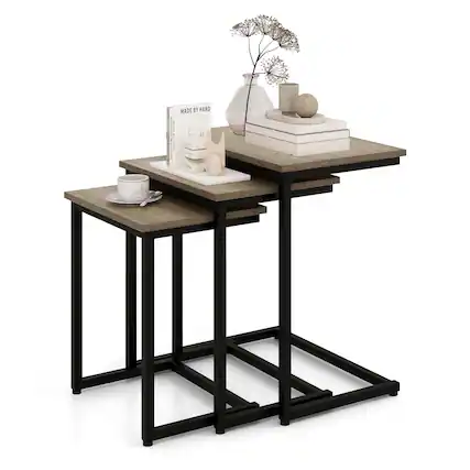 The image features a small table with various items on it. There are two books, one on the left side and the other on the right side of the table. Additionally, there is a vase with a flower in it, placed in the center of the table. A cup can also be seen on the left side of the table. The table is black and has a wooden top.