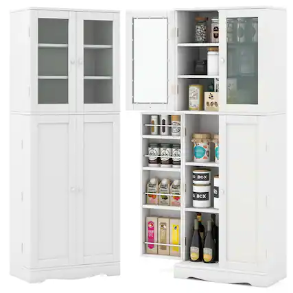 The image shows two white cabinets, one of which is open, revealing a variety of food items and bottles inside. The open cabinet contains a mirror, and the shelves are stocked with food items such as jars, bottles, and a box. The other cabinet is closed, and it appears to be a pantry with shelves for storing food items. The scene suggests a well-organized and stocked kitchen.