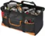 The image shows a black and orange tool bag filled with various tools, including a drill, a saw, and a wrench. The bag is likely used by a construction worker or someone who needs to carry their tools around for work purposes. The bag is open, revealing the tools inside, and it is placed on a white background.