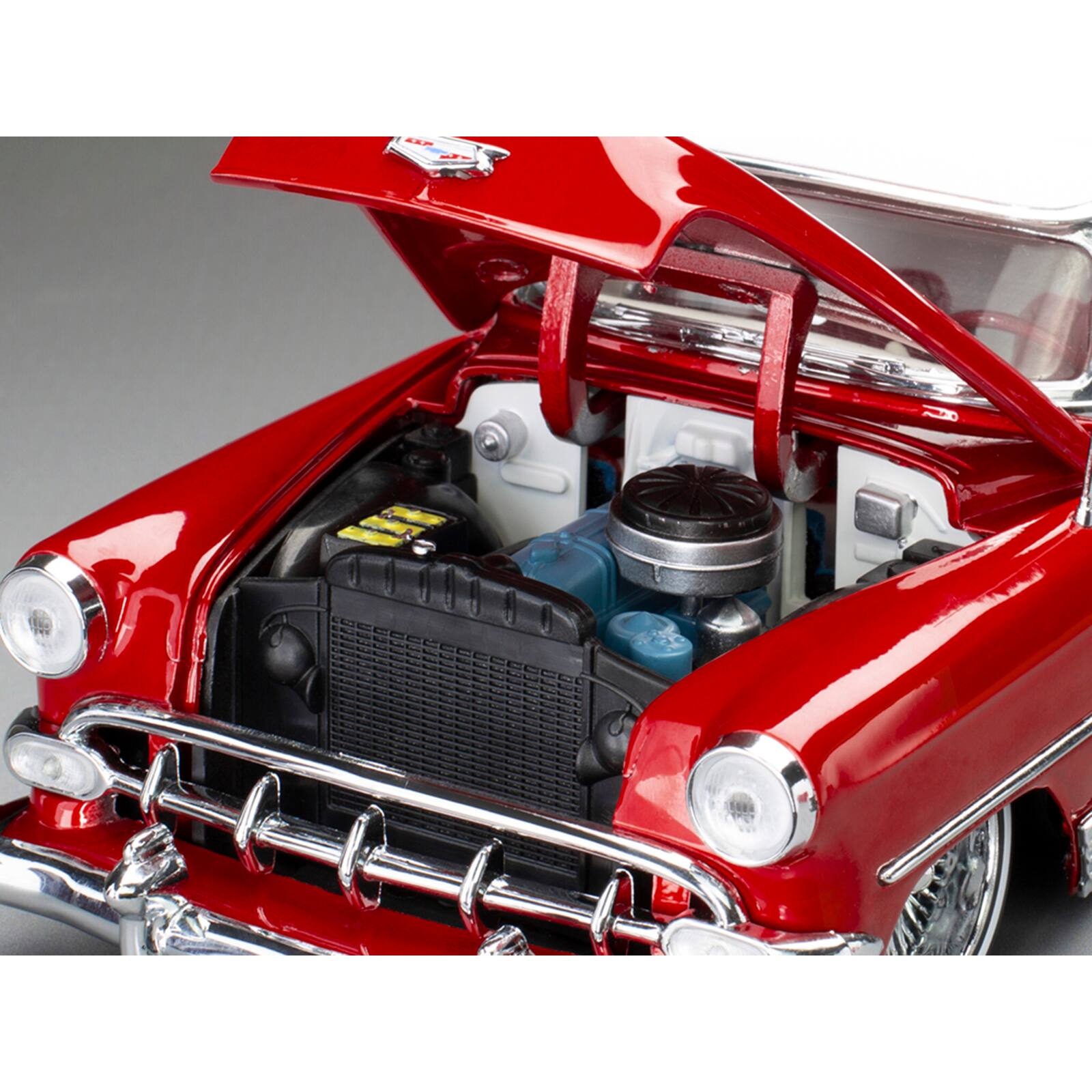 Alt View 2. Sun Star - 1954 Chevrolet Bel Air Lowrider Red Metallic with White Top and White Interior 1/18 Diecast Model Car by Sun Star.
