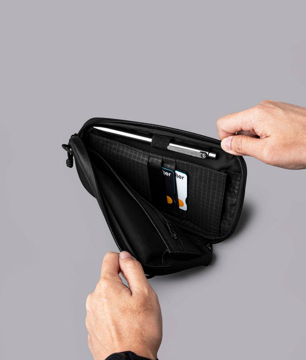Alt View 6. ALPAKA - Bravo Passport Pouch Sling Bag for Men, Passport Holder for Travel, Fits iPhone Pro Max, RFID, AirTag Sleeve - Black Axoflux 210D.