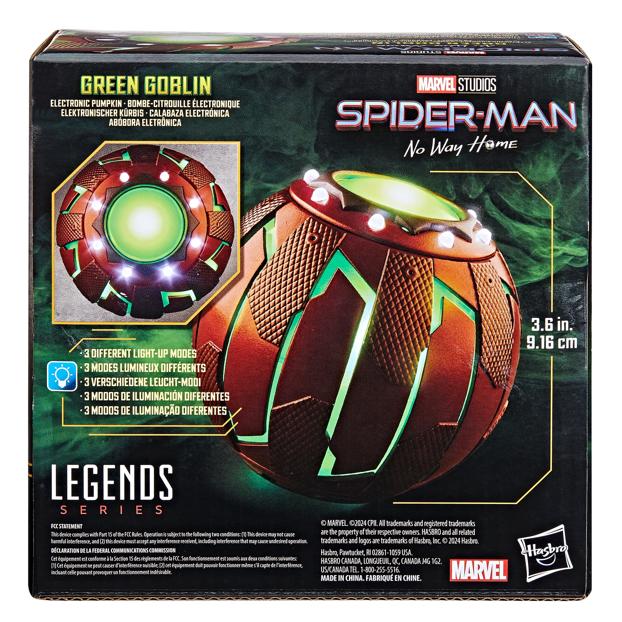 The box contains a Spider-Man Green Goblin electronic pumpkin bomb. It has three different light-up modes, and it is part of the Legends series. The box measures 3.6 inches in size. The product is made by Marvel Studios and Hasbro. The box complies with the Federal Communications Commission regulations.