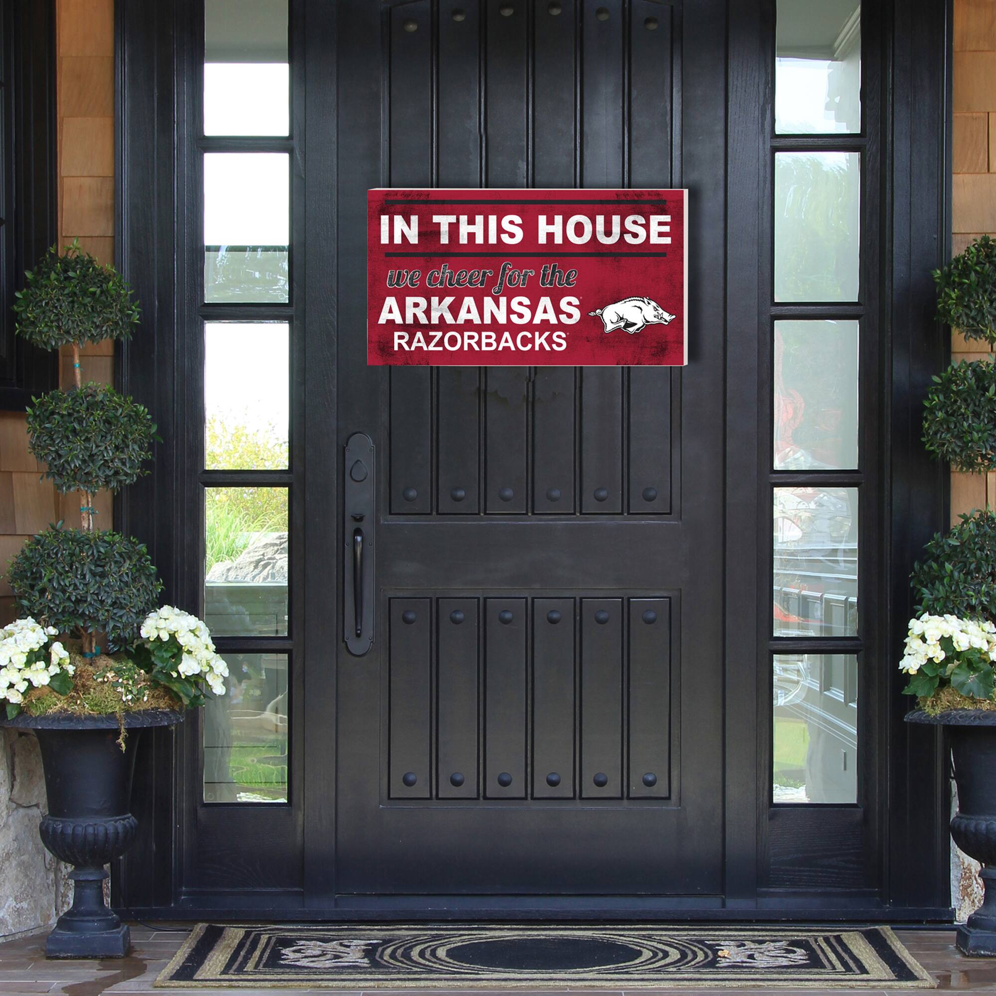IN THIS HOUSE  
we cheer for the  
ARKANSAS RAZORBACKS