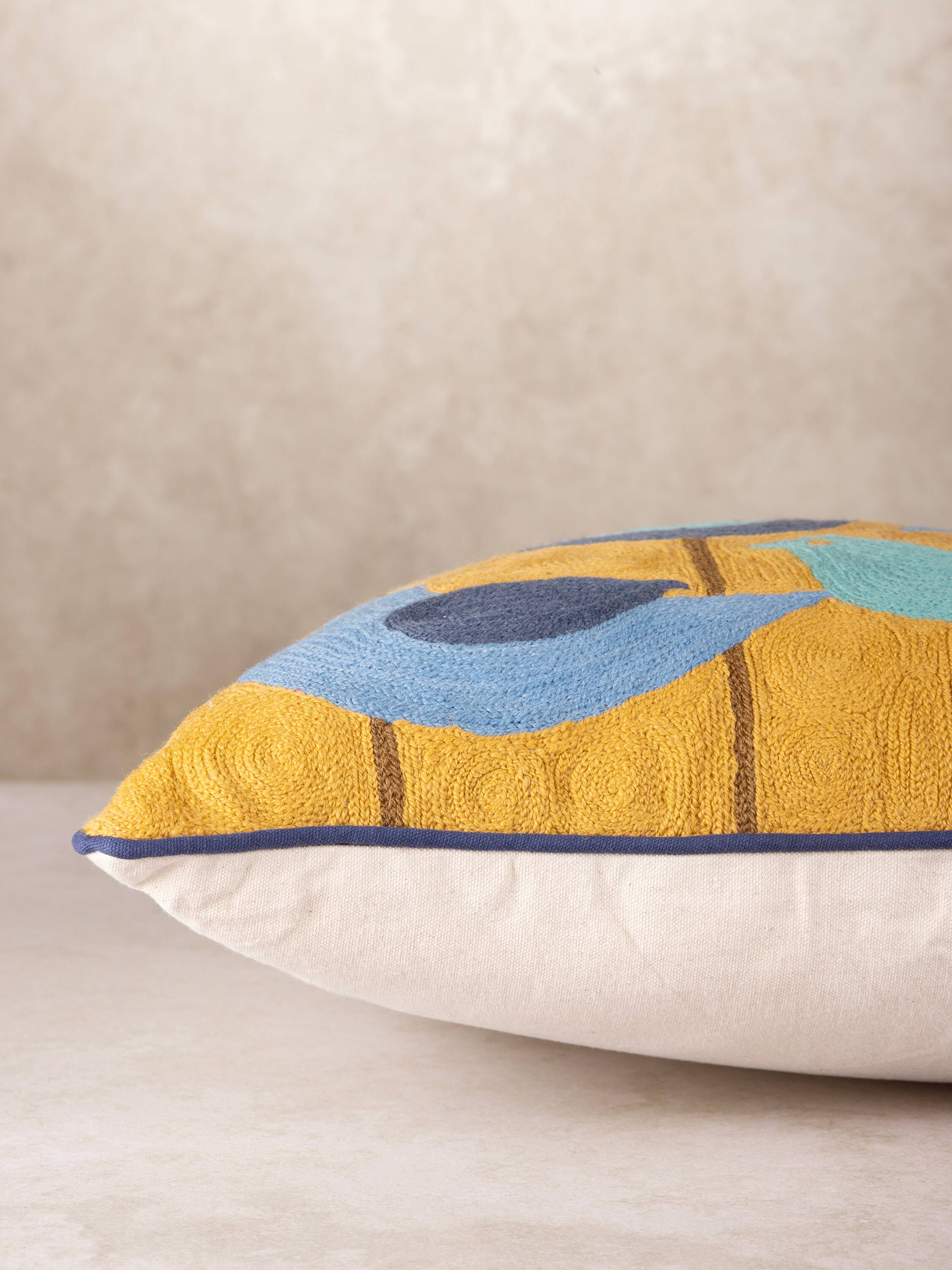 Left. GAURI KOHLI - Aloha Pillow - Shades of blue and mustard.