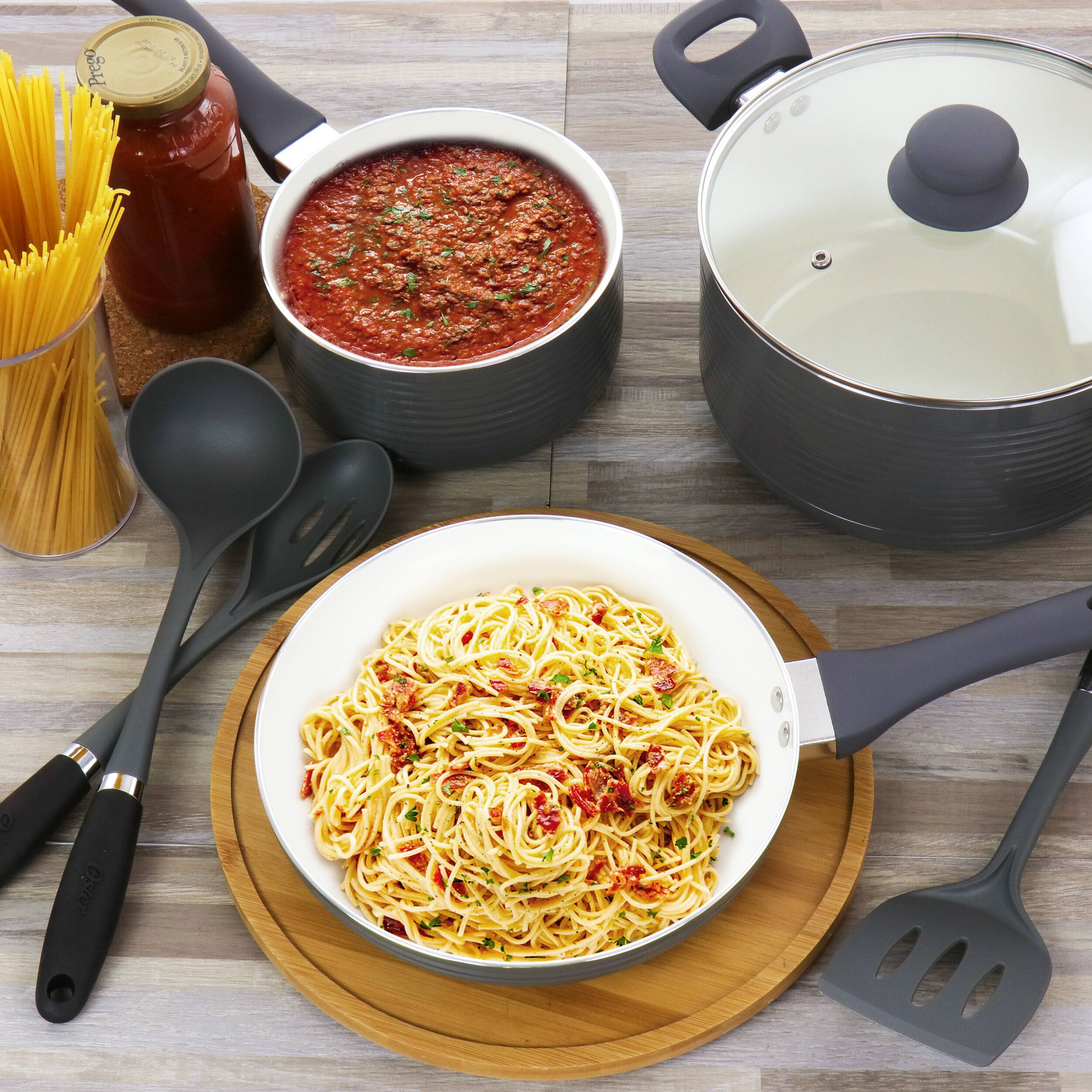 Prego sauce is placed on the table, along with a bowl of pasta and a pot of sauce.