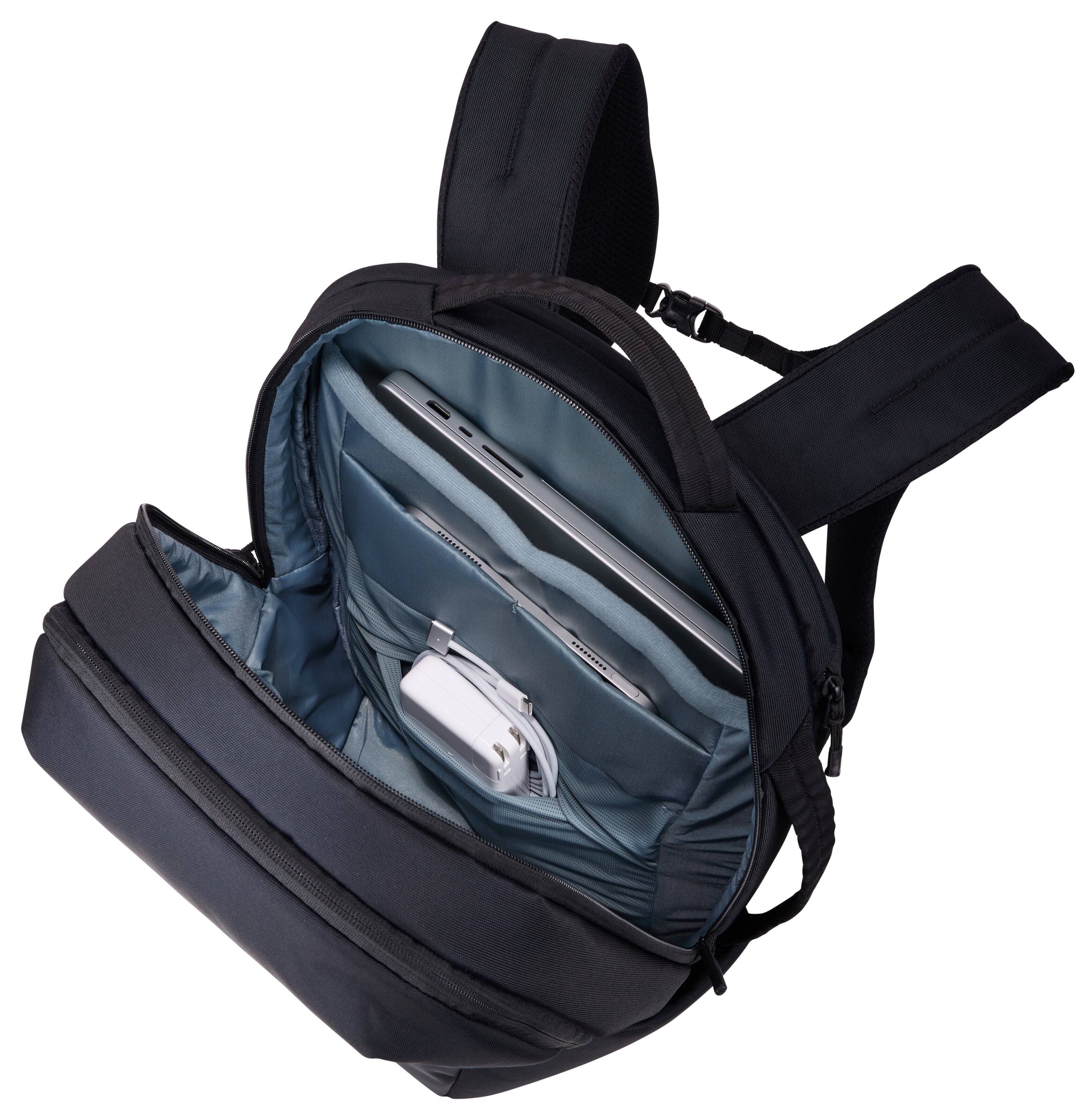 The image shows a black backpack with a teal interior. Inside the backpack, there is a laptop and a power bank. The backpack has multiple compartments and adjustable straps.