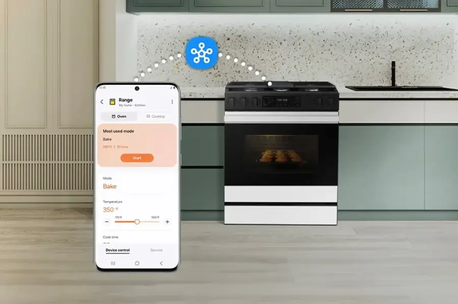 The image shows a kitchen with a stove and oven, and a cell phone is placed above the oven. The text on the image reads "12:45 Range My home Kitchen Oven Cooktop Most used mode Bake 220C 125/ - 560F + Cook time Device control Service." This text suggests that the oven is being used for baking at a temperature of 220 degrees Celsius, and the cooking time is being monitored by the device control service. The cell phone may be used to control the oven remotely or to receive notifications about the cooking progress.
