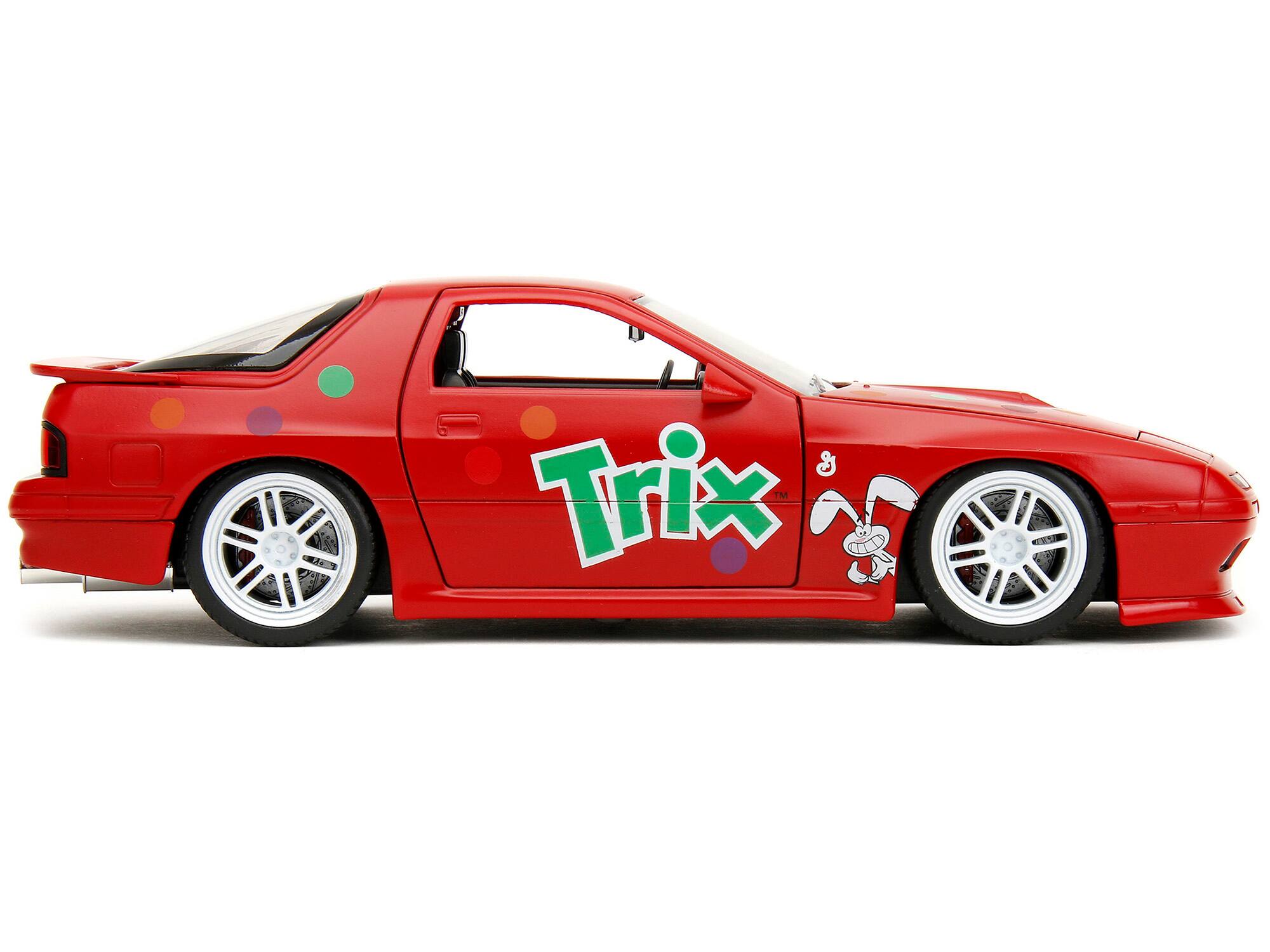 Left. Jada - 1985 Mazda RX-7 RHD Red w/ Graphics & Trix Rabbit Figure Trix Cereal Hollywood Rides Series 1/24 Diecast - Red.
