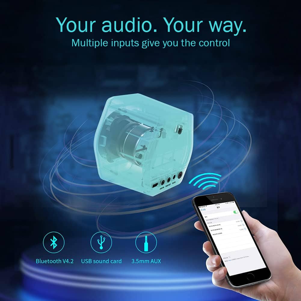 The image features a person holding a cell phone next to a computer speaker. The speaker is shown with a USB sound card and a 3.5mm AUX input. The person is likely using the speaker to enhance their audio experience or to connect it to their device. The scene suggests that the speaker is designed to provide a personalized audio experience with multiple input options for control.