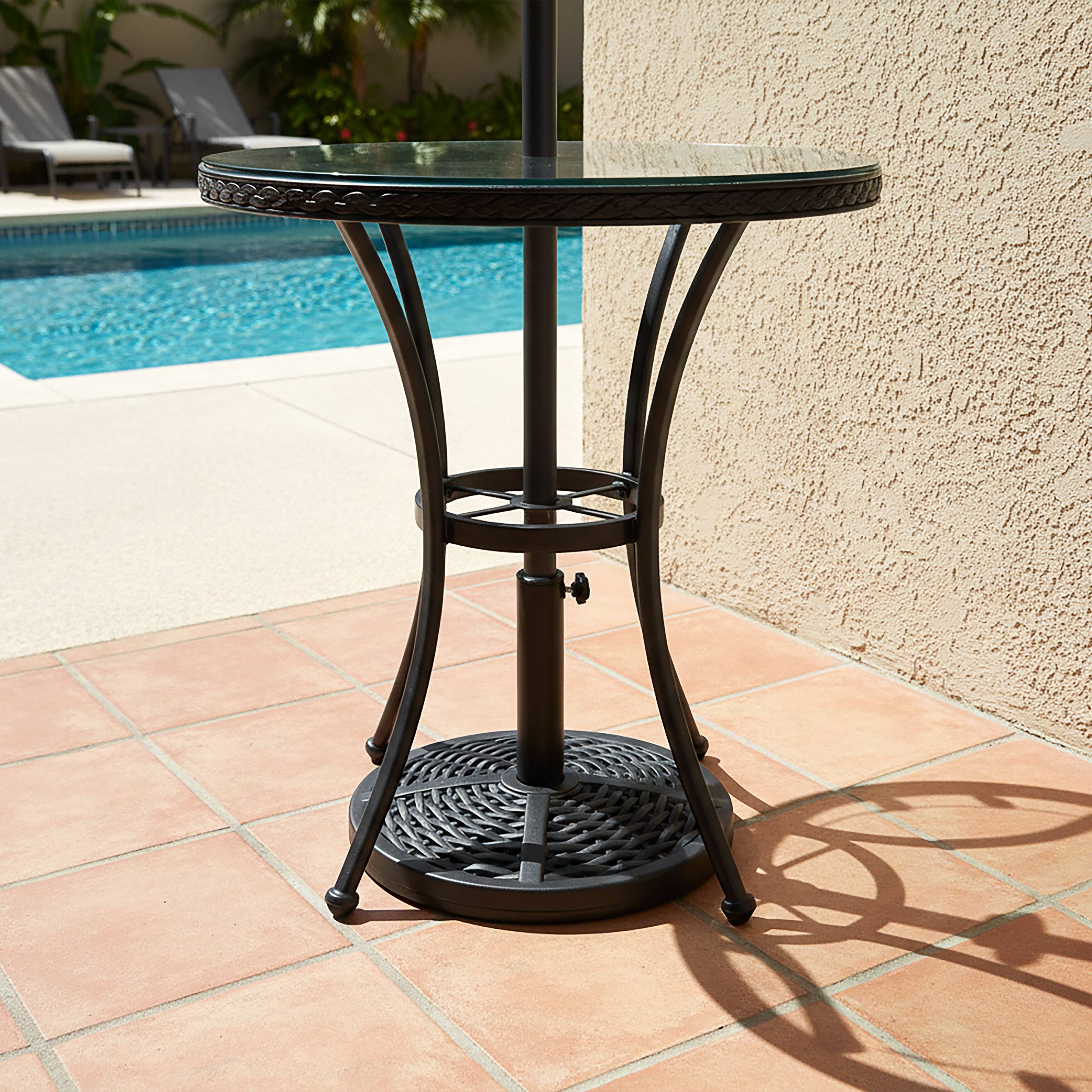 Angle. Nuu Garden - Outdoor 26 lb. 18'' Round Patio Umbrella Base, Polyethylene and Concrete - Black.