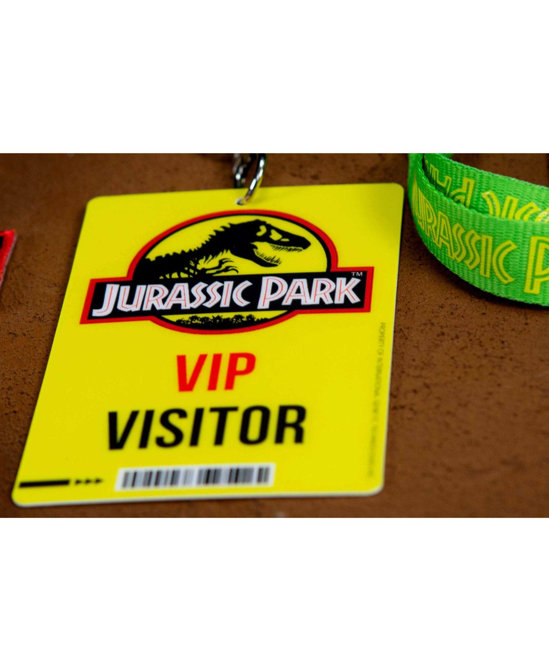 Jurassic Park TM is a registered trademark. The yellow lanyard and tag in the image are for a Jurassic Park VIP visitor.