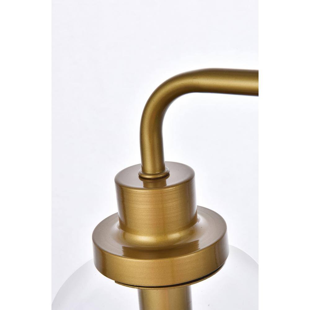 Left. Living District - Hanson 3 lights bath sconce in brass with clear shade - Brass And Clear Shade.