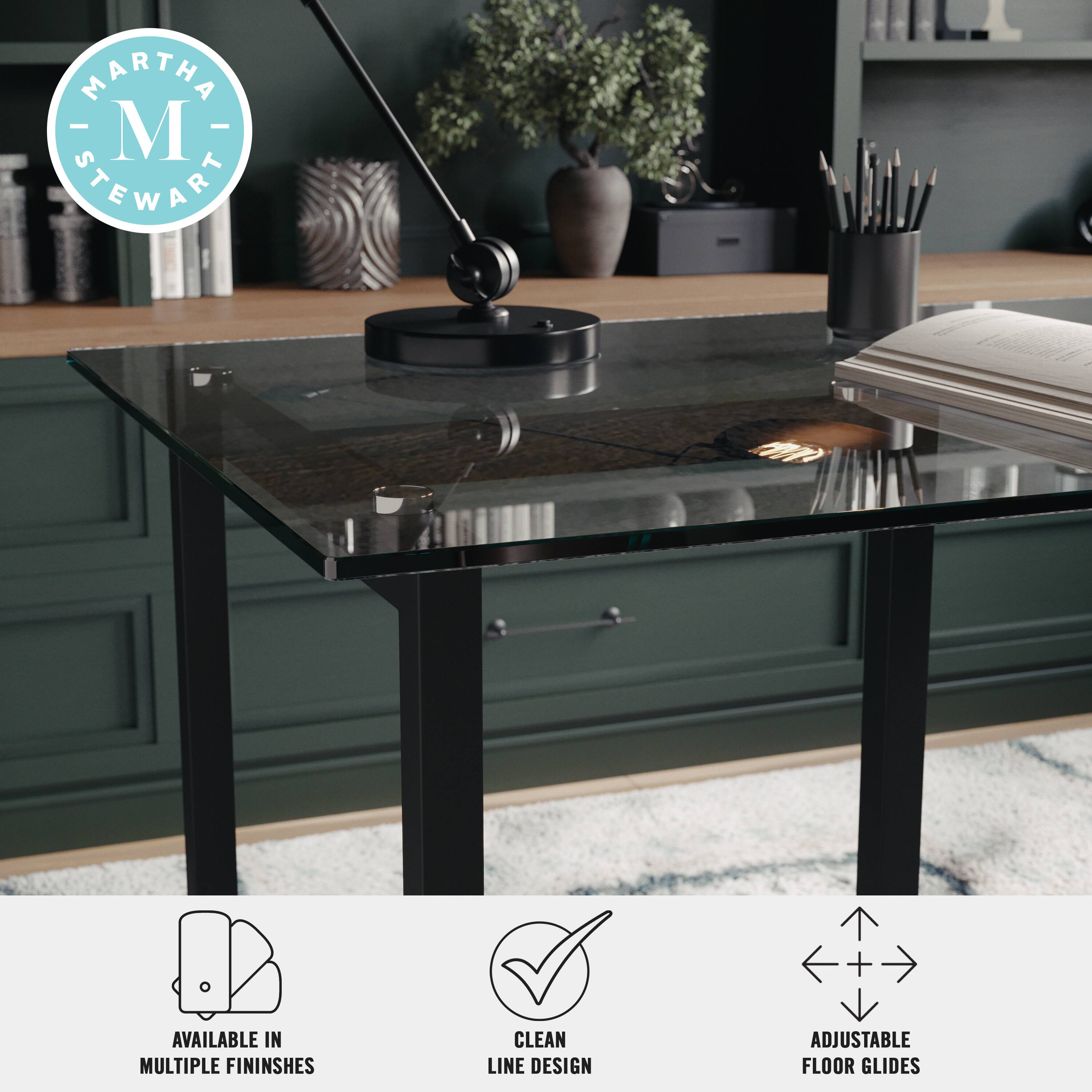 Martha Stewart is the brand associated with the image. The desk is available in multiple finishes and features a clean line design. Additionally, the desk has adjustable floor glides for added stability and comfort.