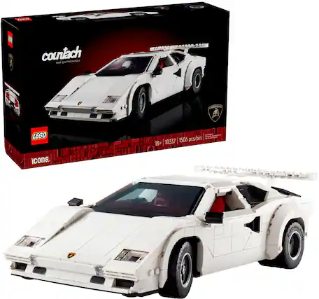 The image features a white Lamborghini Countach model car made by Lego. The car is displayed in a box, which also contains a booklet. The car is a replica of a sports car and is made of Lego bricks. The car is white and has a distinctive design, making it an attractive display piece for car enthusiasts and Lego collectors.