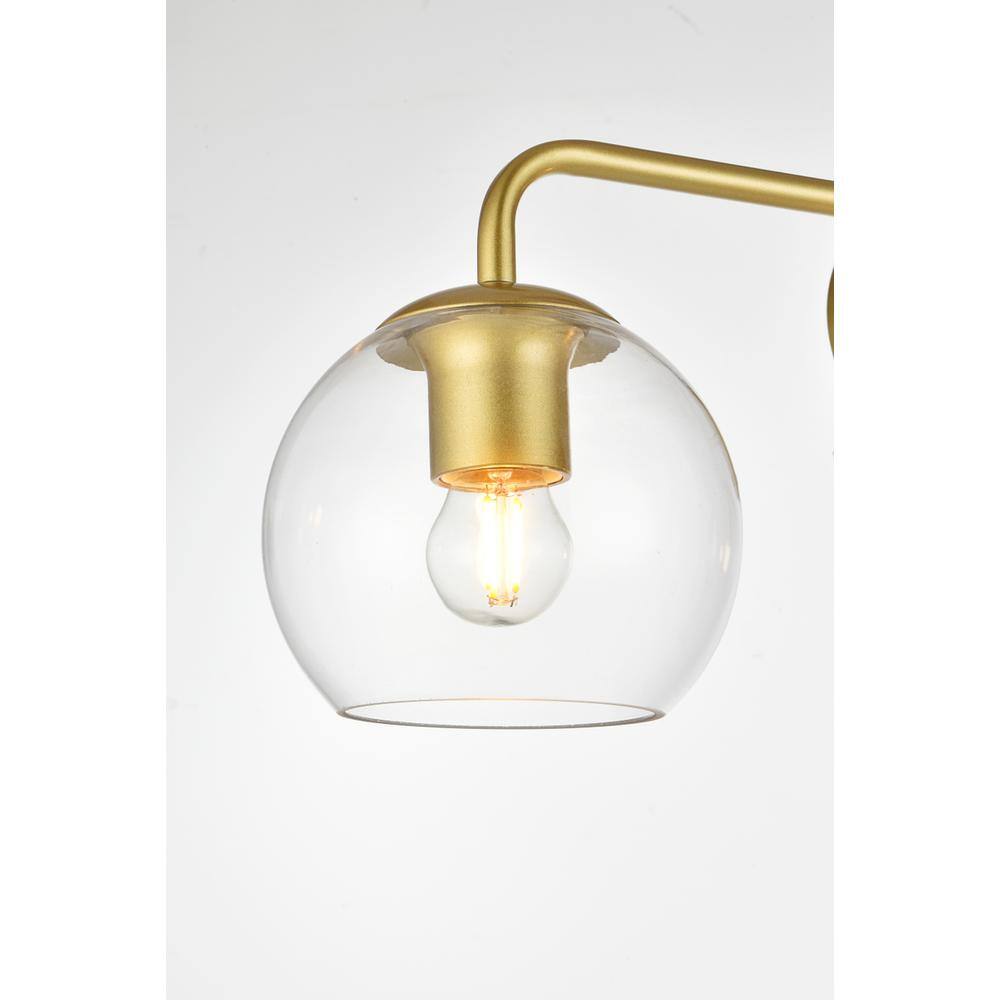 Left. Living District - Genesis 3 light Brass and Clear Bath Sconce - Brass And Clear.