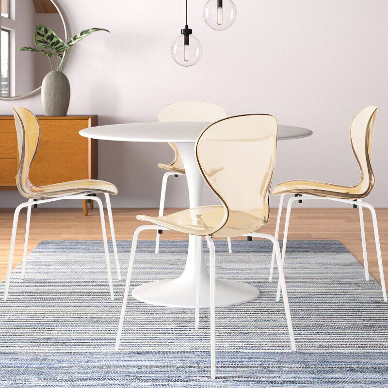 Angle. LeisureMod - Oyster Modern Clear Plastic Dining Chair, Stackable Ergonomic Accent Chair with Powder Coated Steel Legs - Amber.