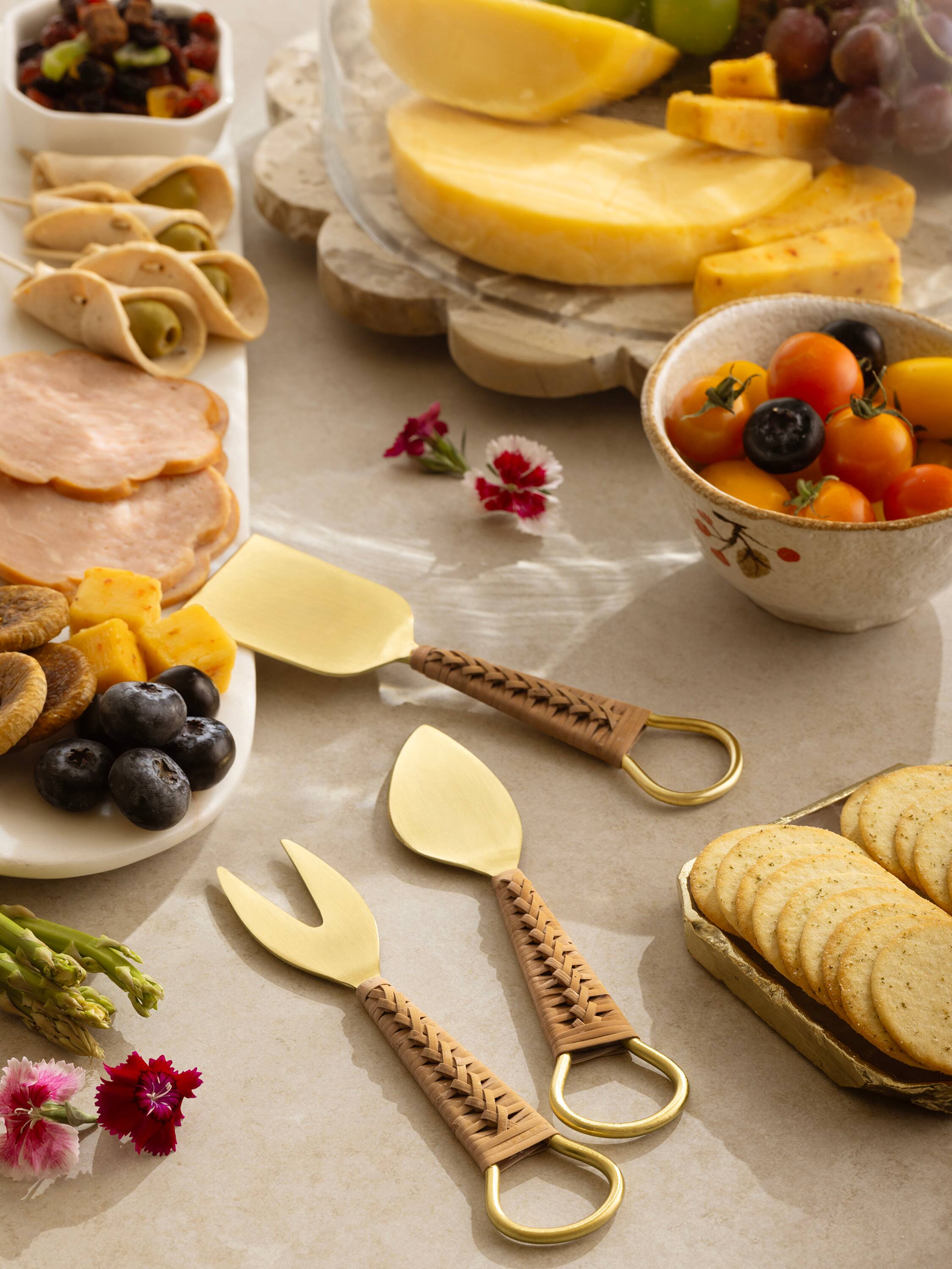 Left. GAURI KOHLI - Helsinki Cheese Knives - Pine brown, matte gold.