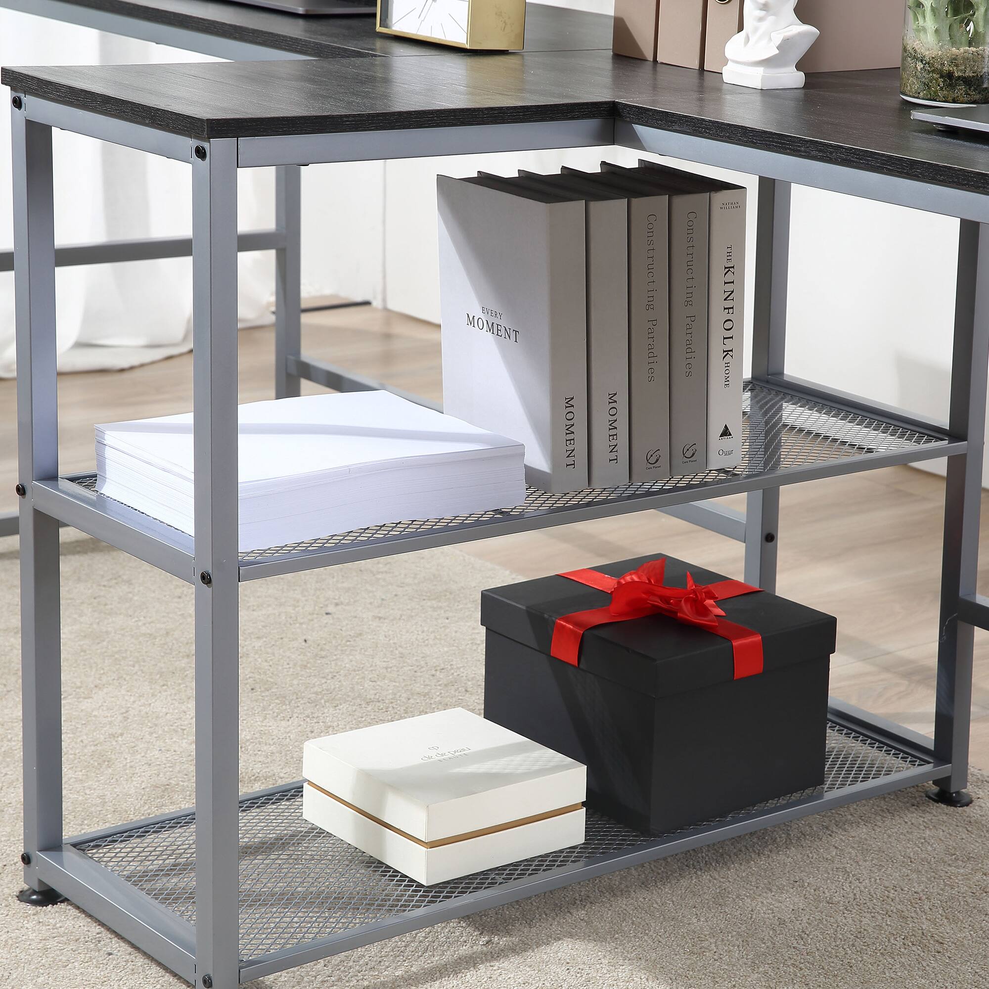 Sure, here is the corrected and grouped text from the image:

**Top Shelf:**
- "Constructing Paradise"
- "Constructing Paradise"
- "Constructing Paradise"
- "The Kinfolk Home"

**Middle Shelf:**
- "MOMENT"
- "MOMENT"

**Bottom Shelf:**
- "MOMENT" (on the white box)

**Other Text:**
- "EVERY MOMENT" (on the white bag)