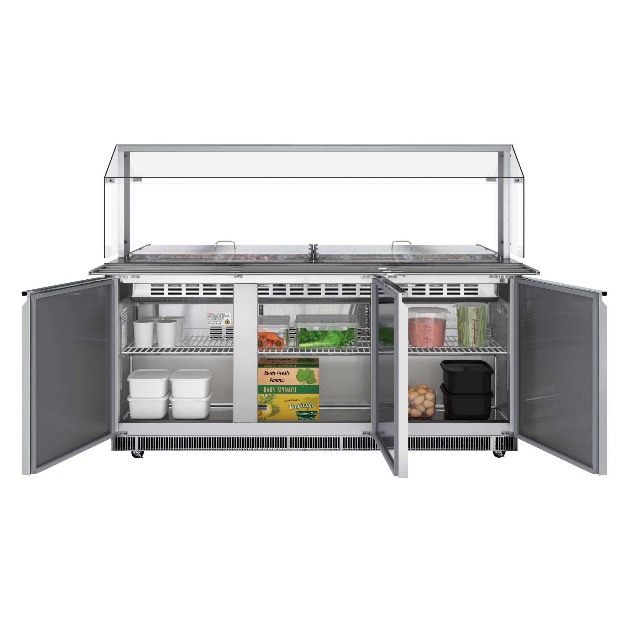 The image shows a refrigerator with a variety of food items inside. There are several bowls and cups placed on different shelves, as well as a carrot and a banana. The refrigerator is filled with a variety of foods, including a box of spinach, a container of yogurt, and a container of pink sauce. The refrigerator is open, revealing the contents inside.