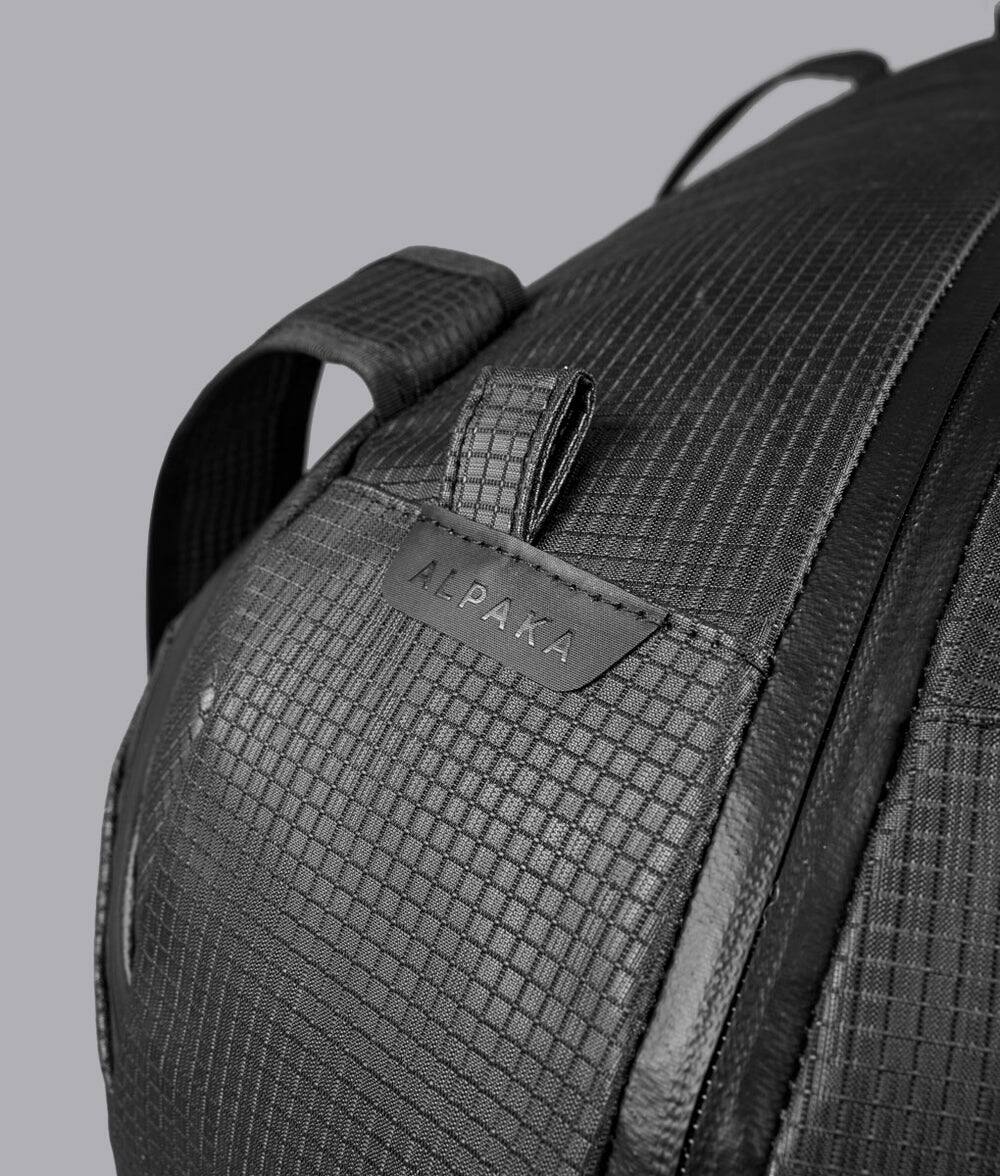 Alt View 9. ALPAKA - 35L Lightweight Duffel Bag for Gym, Weekend Trips & Carry-On Travel, Momentum Duffel, Weather-Resistant - Axodyne hybrid Black.