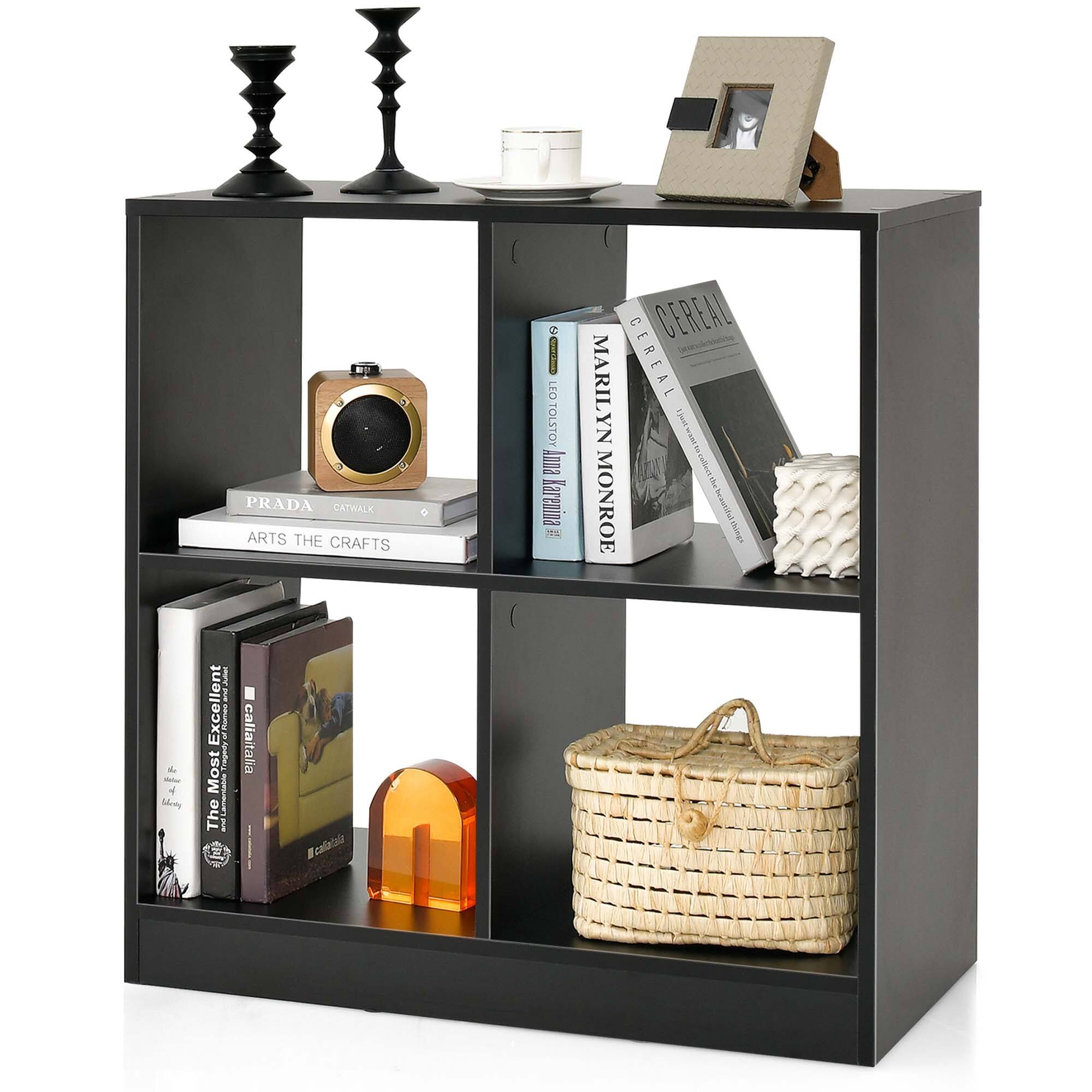 The image features a black bookshelf with various items on it. There are multiple books of different sizes, including a book by Leo Tolstoy. In addition to the books, there are two vases, one on the left side and the other on the right side of the bookshelf. A clock is also present on the top shelf of the bookshelf. A handbag is placed on the bottom shelf, and a bowl is located on the left side of the bookshelf. The bookshelf is filled with a mix of books, decorative items, and functional objects, creating an organized and visually appealing display.