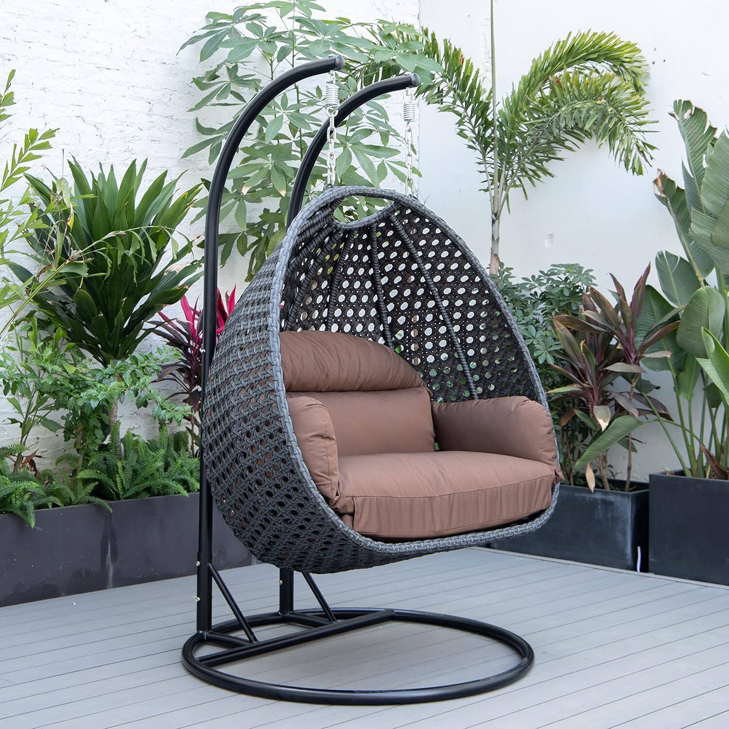 Angle. LeisureMod - Mendoza 2-Person Outdoor Charcoal Wicker Swing Chair - Rust-Resistant Frame, Handwoven Boho Porch Swing with Cushions - Brown.