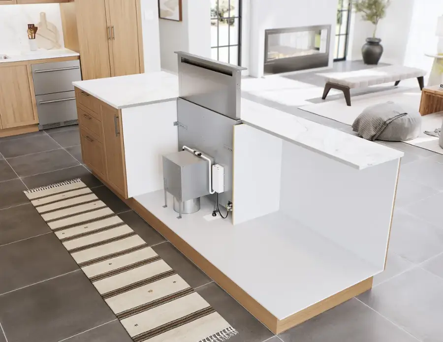 The image features a kitchen with a sink, a refrigerator, and a dishwasher. The kitchen also has a countertop and a stove. The room is well-decorated with a potted plant and a vase. The kitchen is clean and ready for use.
