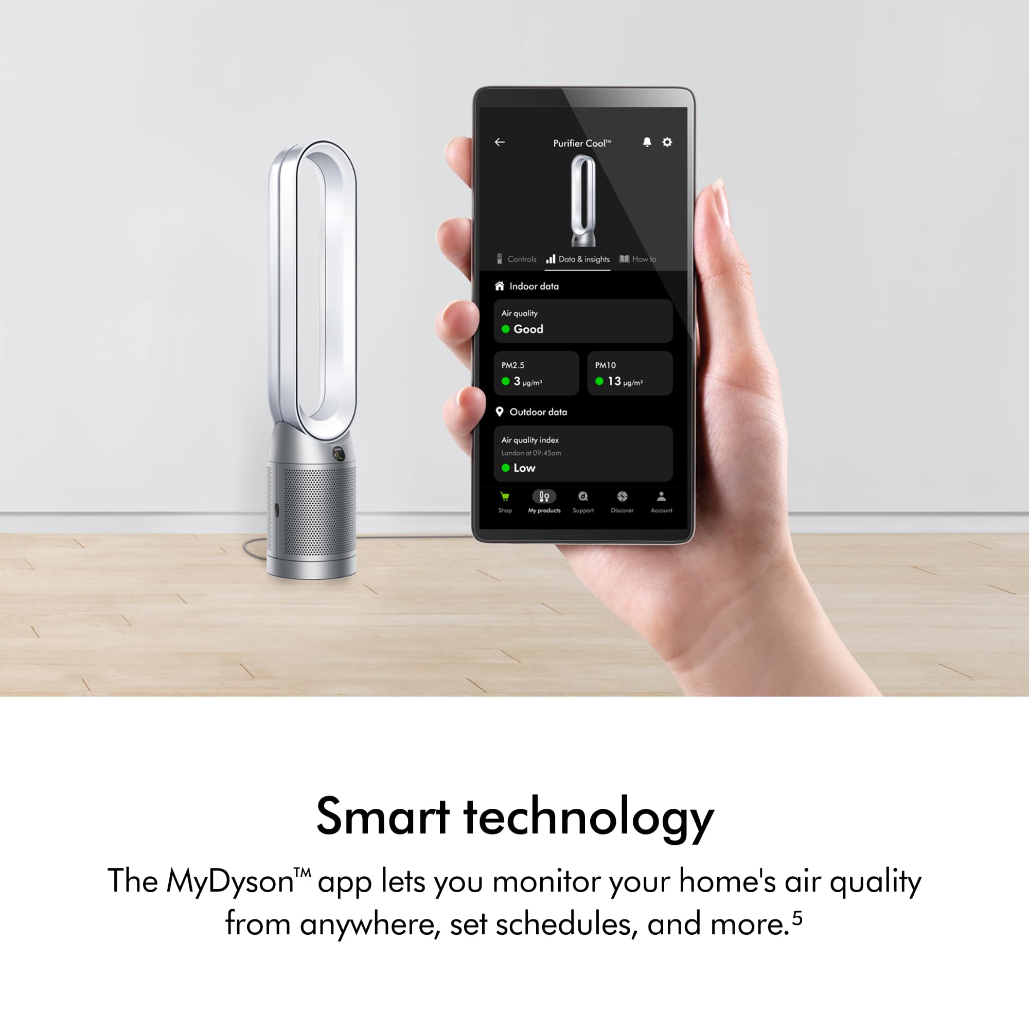 The image features a person holding a smartphone in their hand, with a small device, possibly an air purifier, in the background. The text on the image reads "Smart technology The MyDyson app lets you monitor your home's air quality from anywhere, set schedules, and more." This suggests that the person is using the app to control the air purifier and monitor the air quality in their home. The app likely provides a convenient and efficient way to manage the air purifier and maintain a healthy indoor environment.