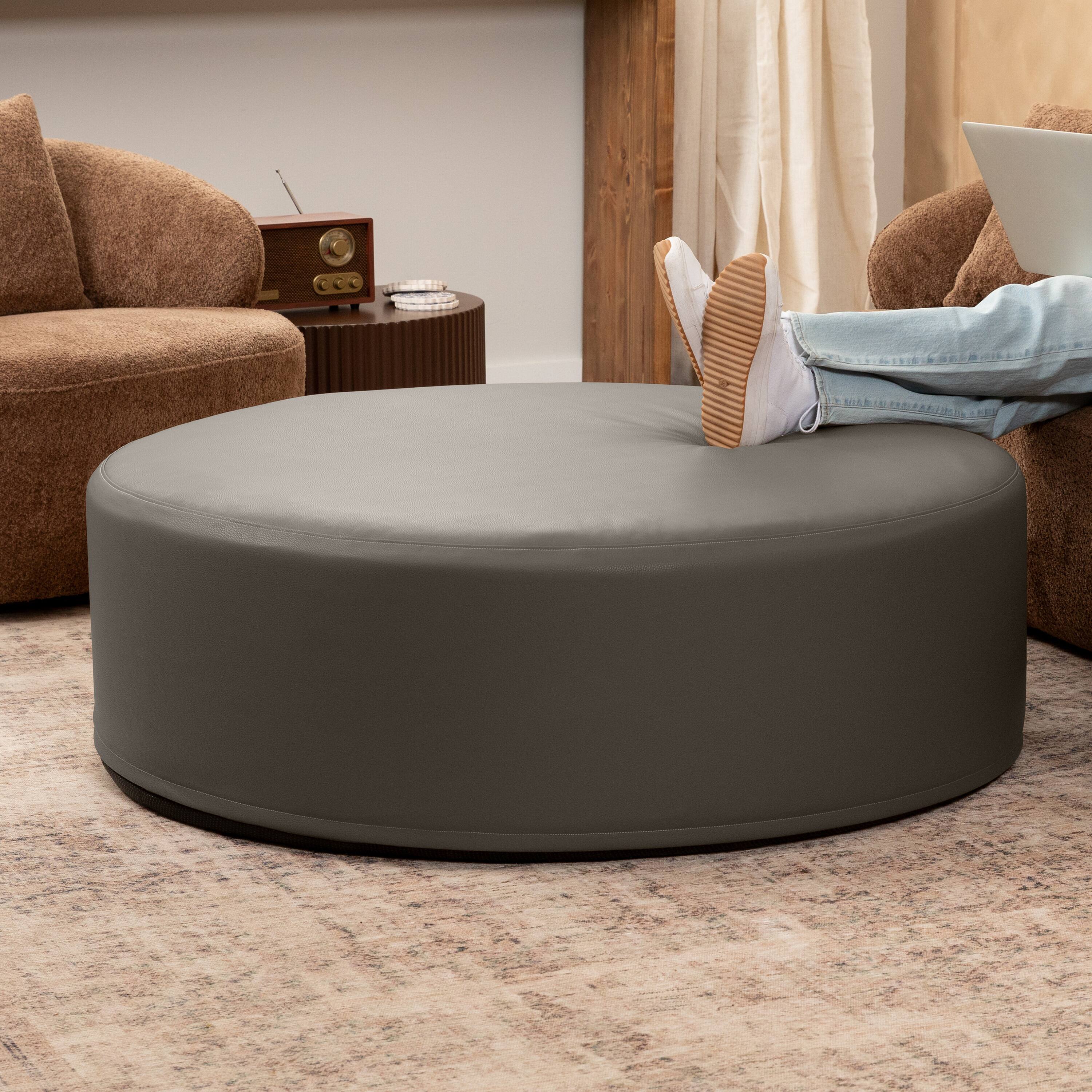 Angle. Jaxx - Jaxx Candler Round Couch Oversized Giant Coffee Table Ottoman 44”, Gunmetal - Faux Leather Gunmetal.
