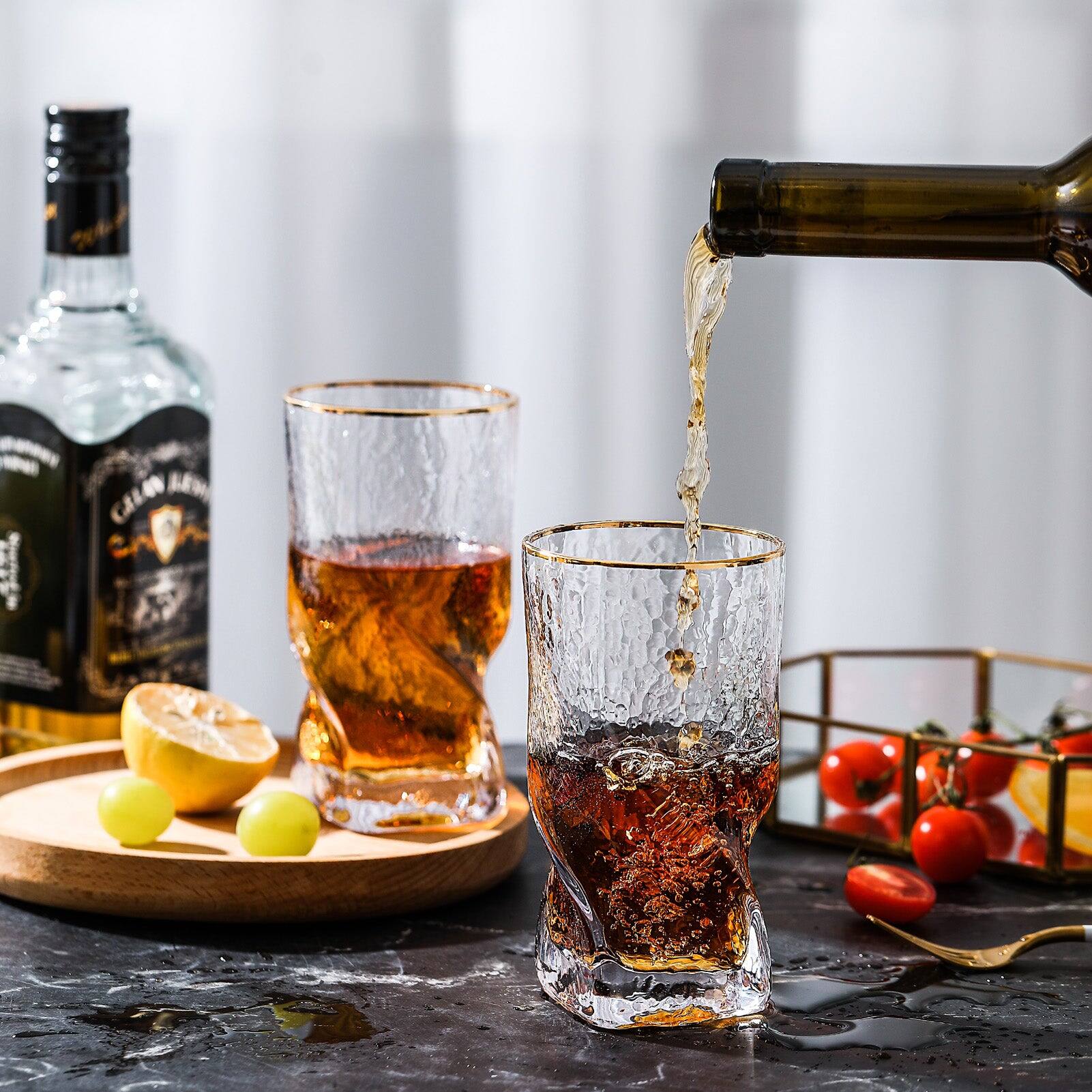 Left. BreeBe - Gold Rimmed Hammer Twist Whiskey Glass (set of 4) - 3.14"W x 5.31" H - Clear with gold rim.