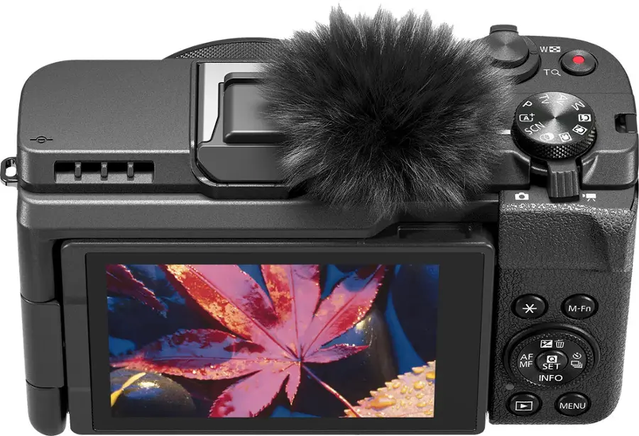 The text on the image reads: "W TQ A Tv Av M (A C SCN C3 C2 CO M-Fn AF MF SET INFO MENU". This text is likely related to the camera's settings or functions, as it is displayed on the screen of the camera.