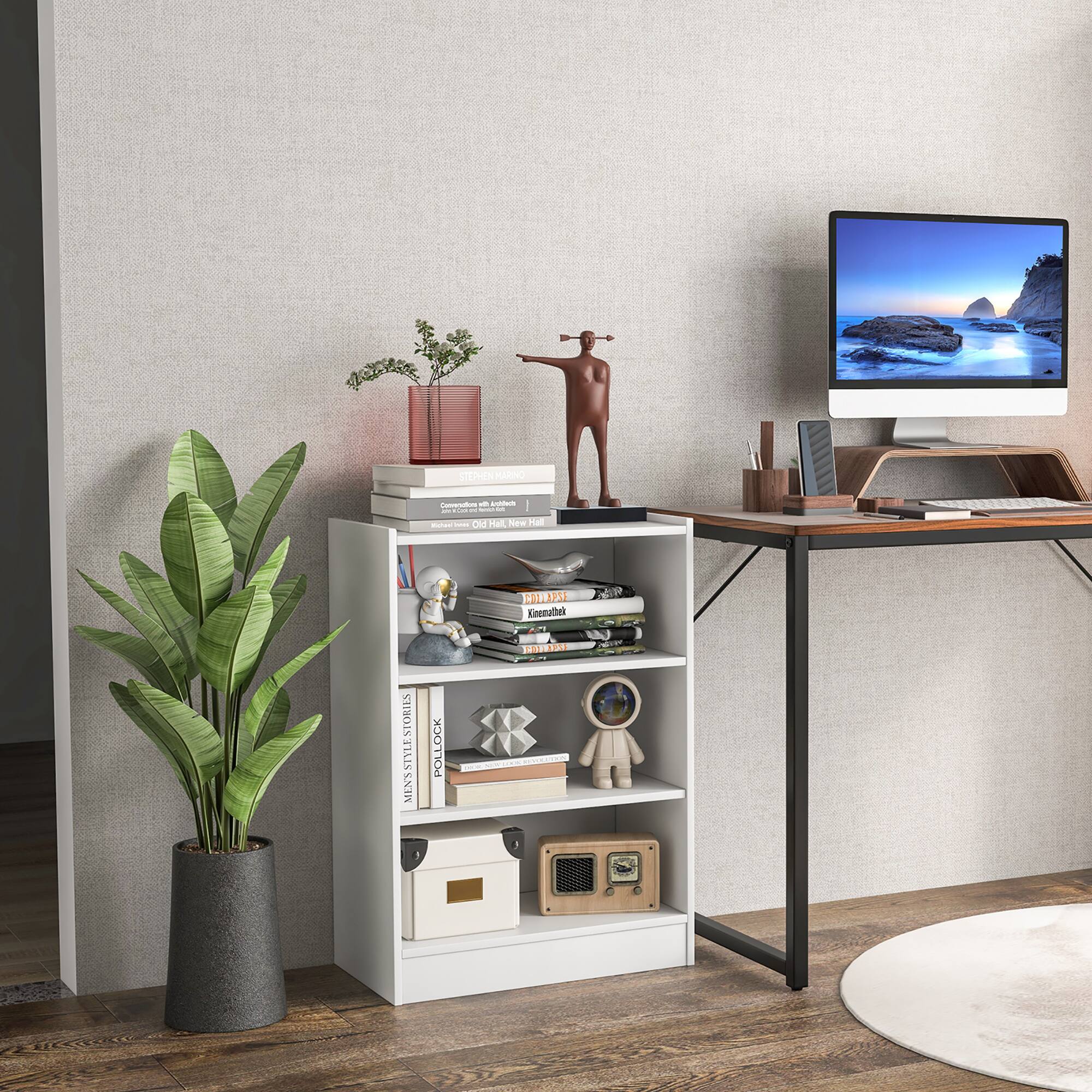 The image features a small desk with a computer monitor, keyboard, and mouse. There is also a potted plant and a bookshelf with books on it. The desk is placed on a hardwood floor.