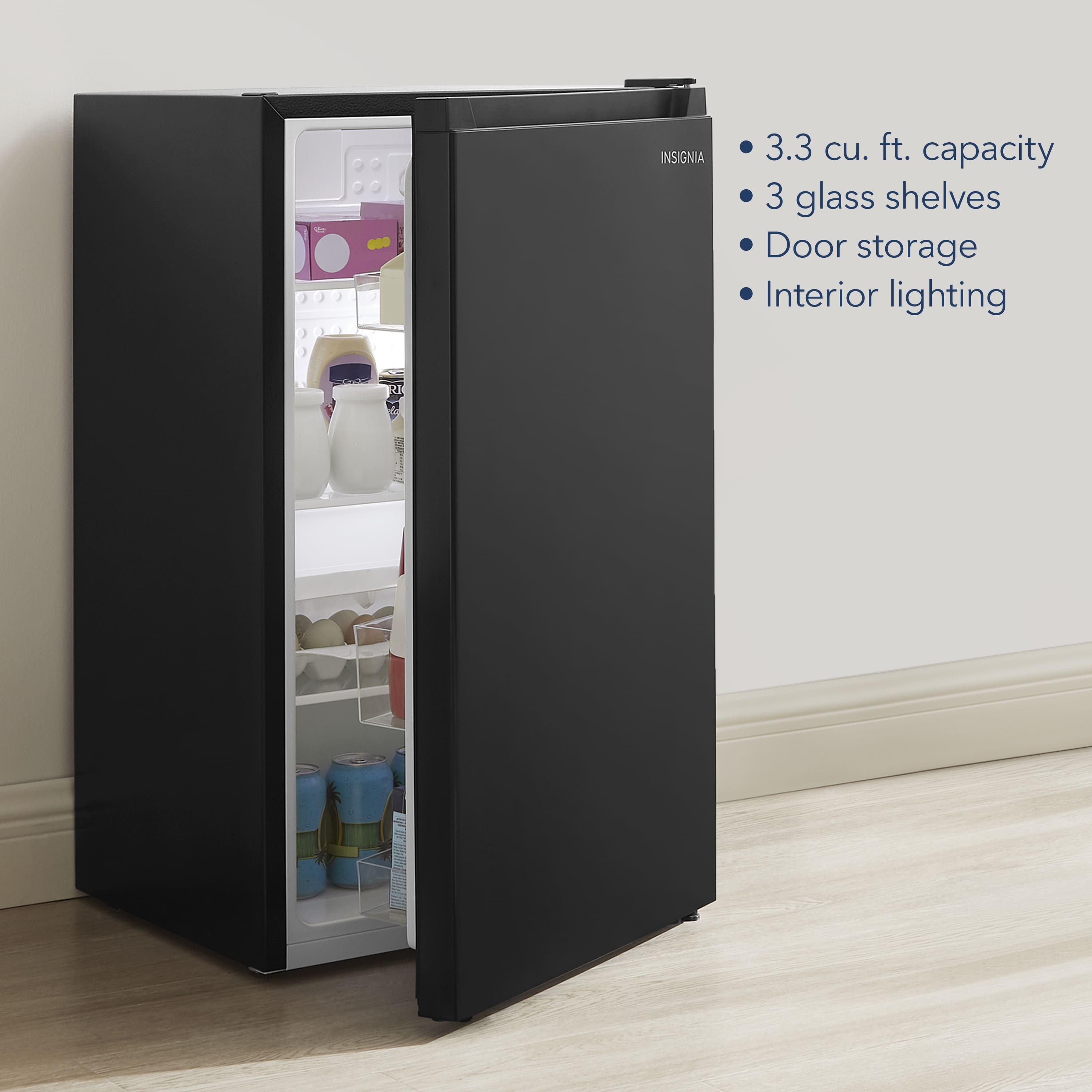 The text on the image reads: "Insignia 3.3 cu. ft. capacity 3 glass shelves Door storage Interior lighting."
