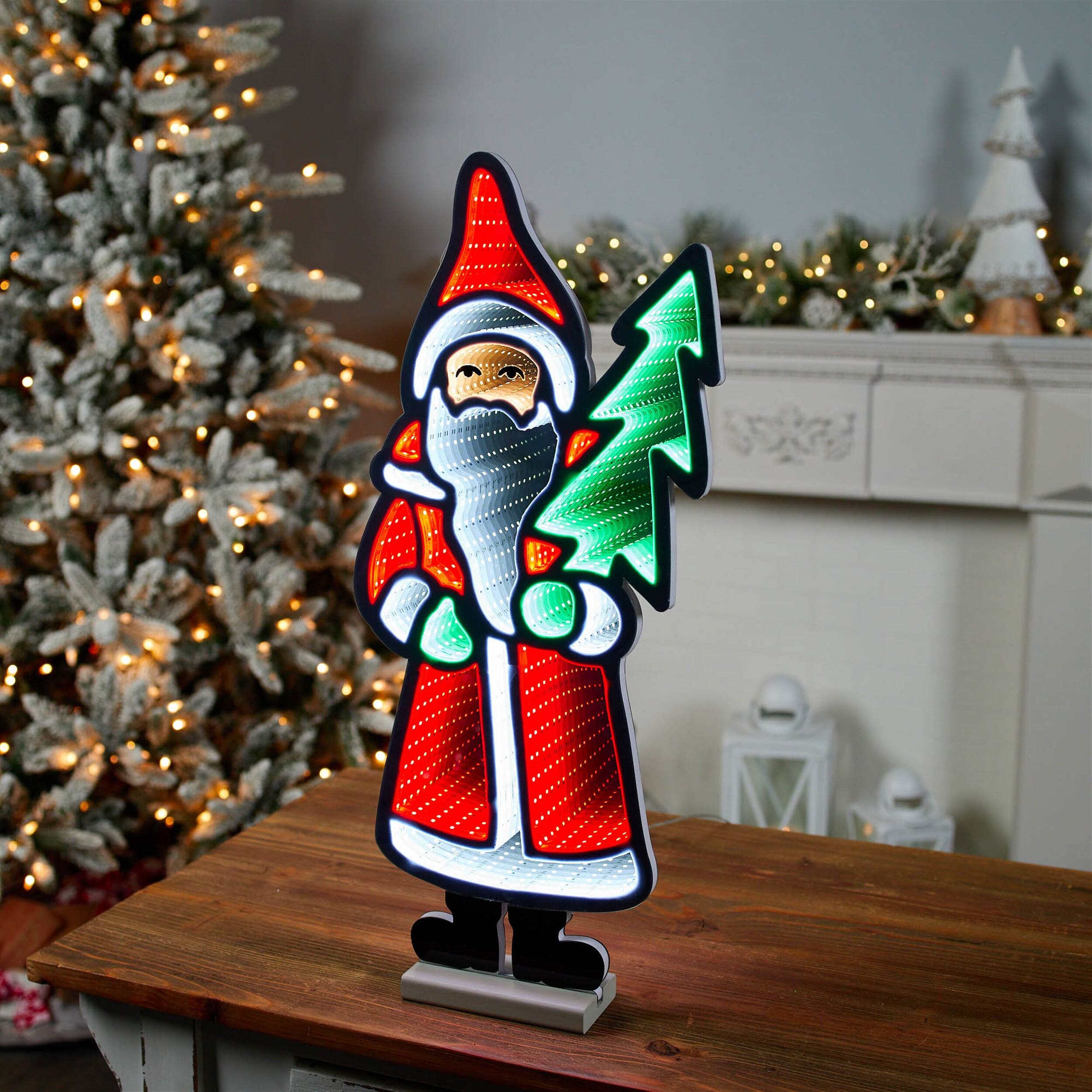Angle. BreeBe - Santa with Pine Tree Ekkolight 23.5"H - Red, White, Green.