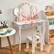 The desk is designed for children, featuring a playful and colorful theme with strawberry patterns. It includes a mirror, a small stool, and storage compartments.