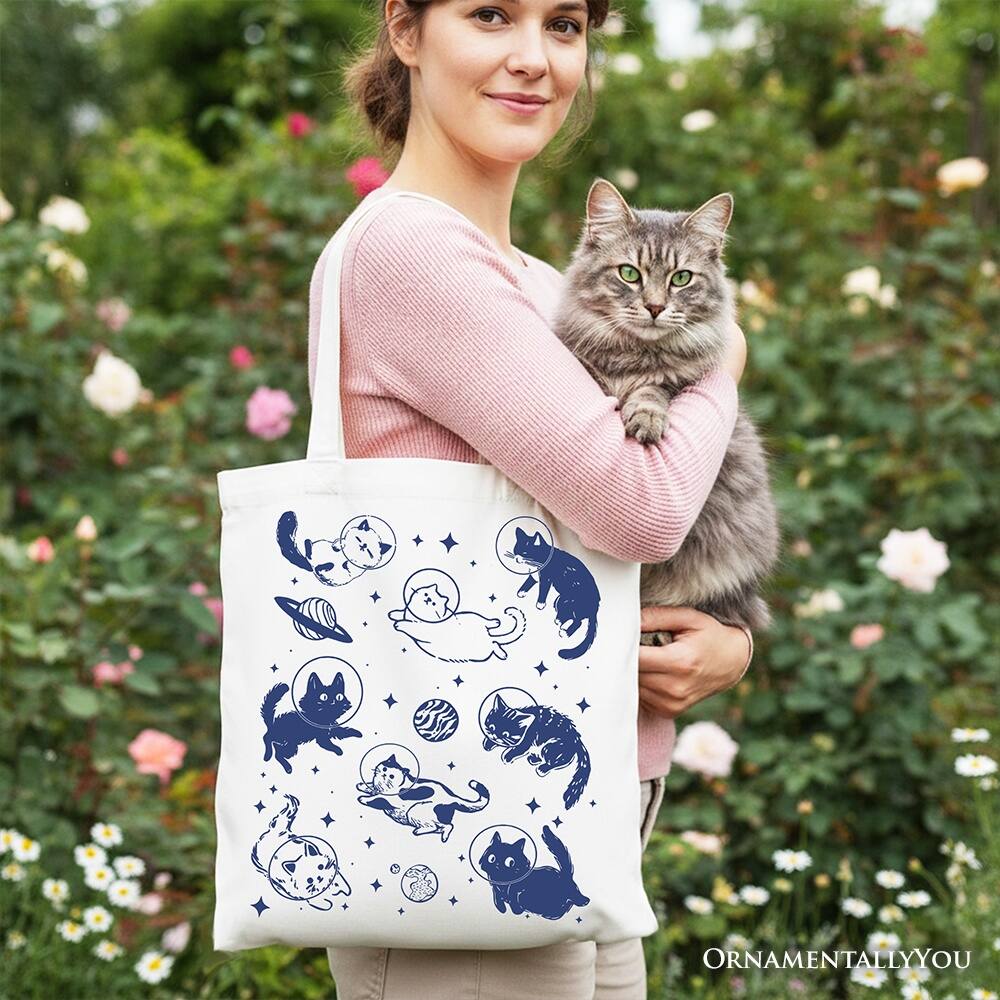 Left. OrnamentallyYou - Cats in Space Retro Canvas Tote Bag, Funny Astronaut Kitty Gift Bag with Cosmic Vibes - White.